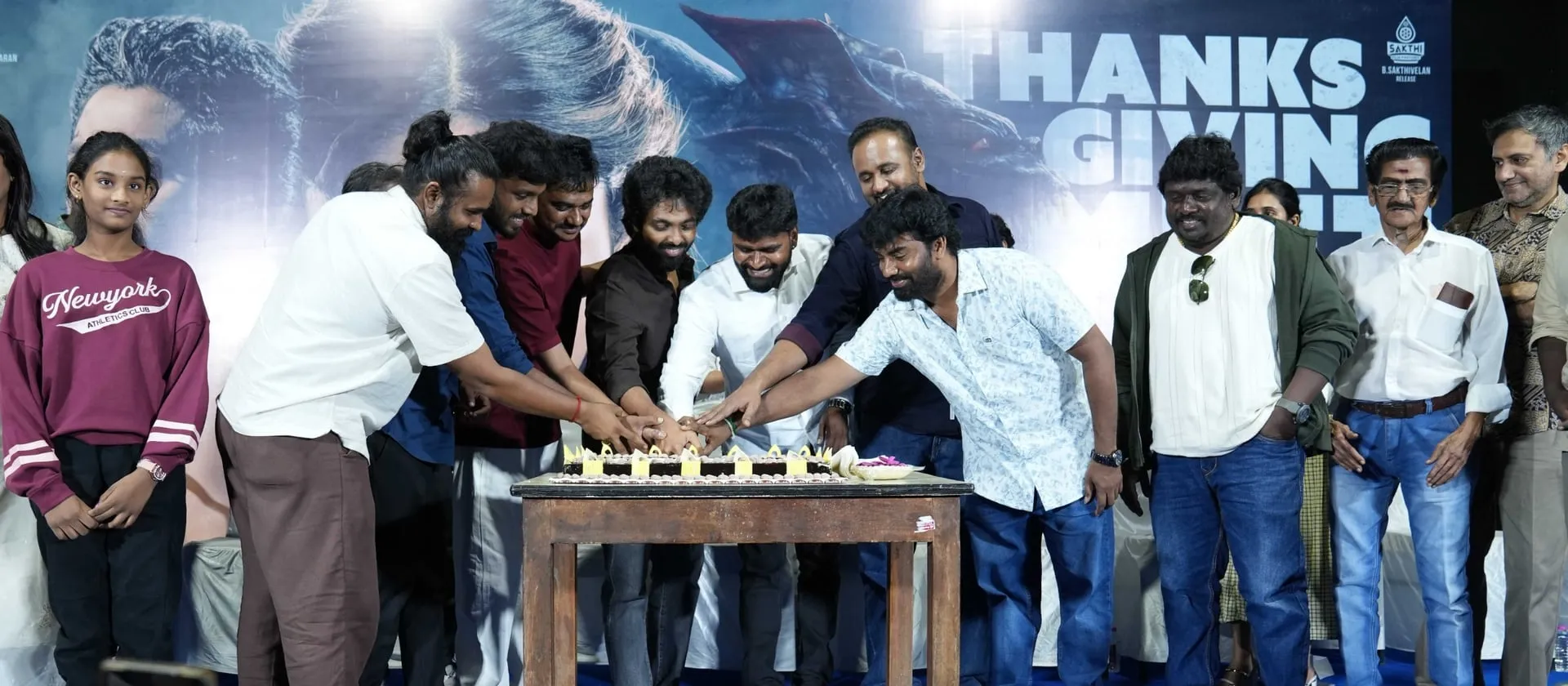 The Immortal cast and crew gathered around the cake to mark the film's reception.