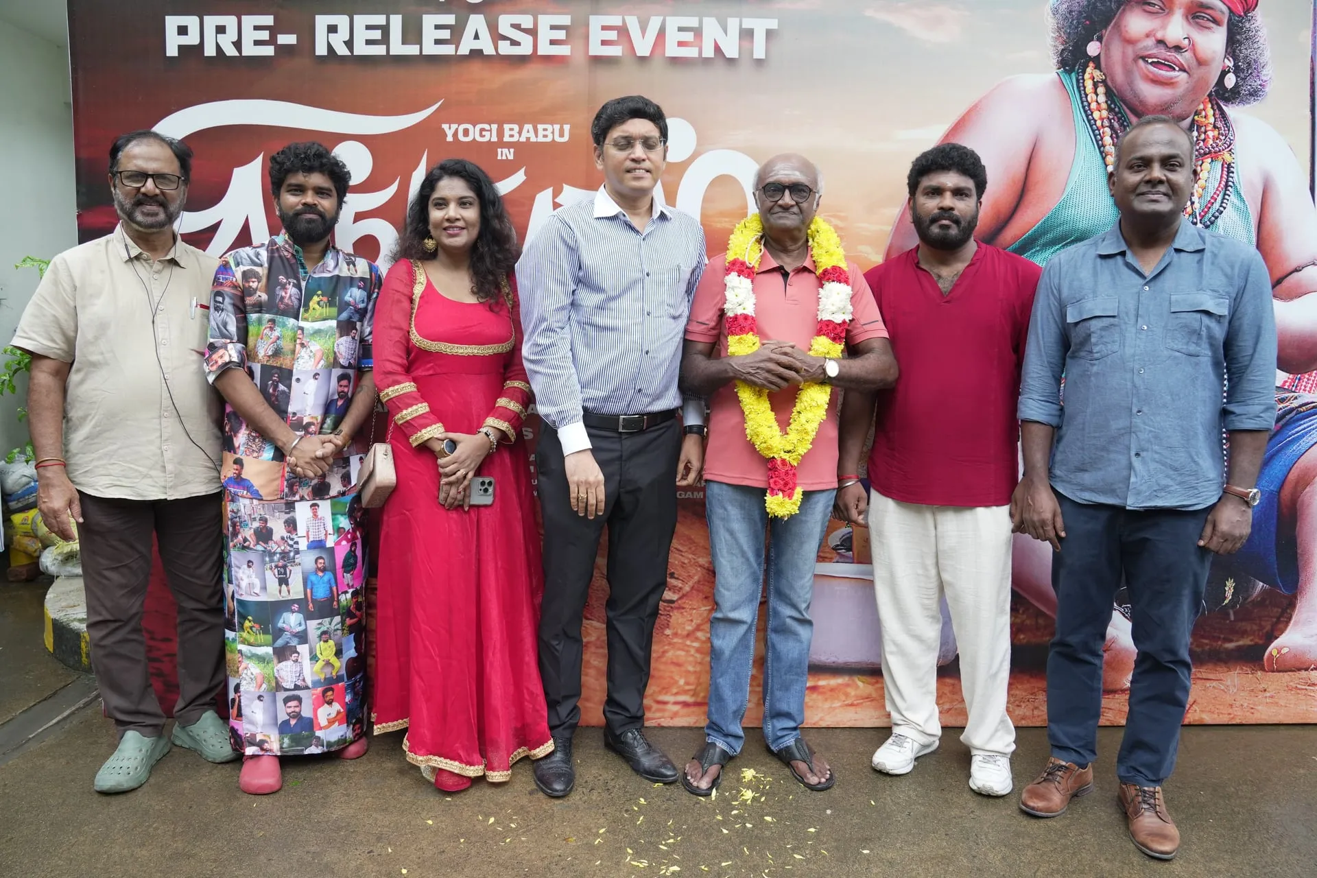 Cast members and guests pose against the Singgaramm backdrop during the gathering.