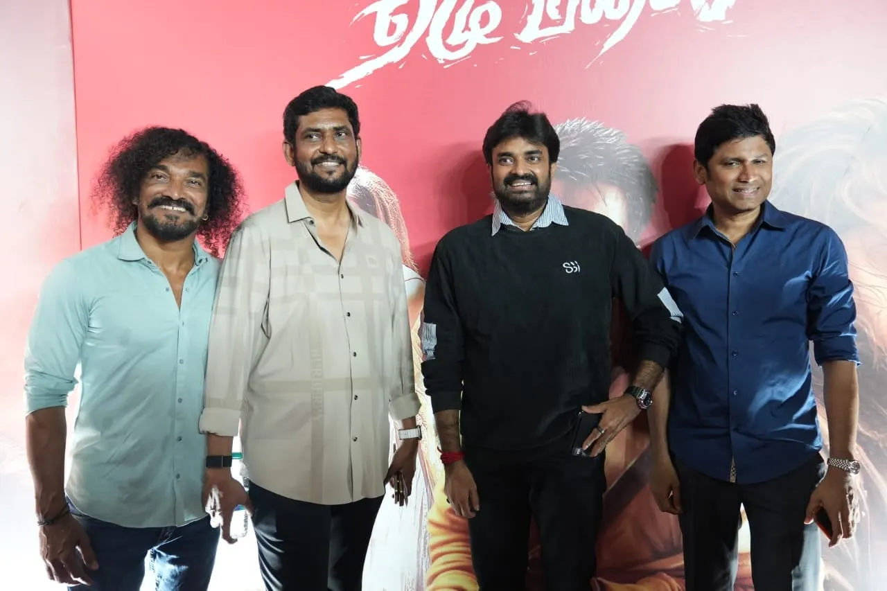 Guests gather for a photograph before the film's red illustrated backdrop