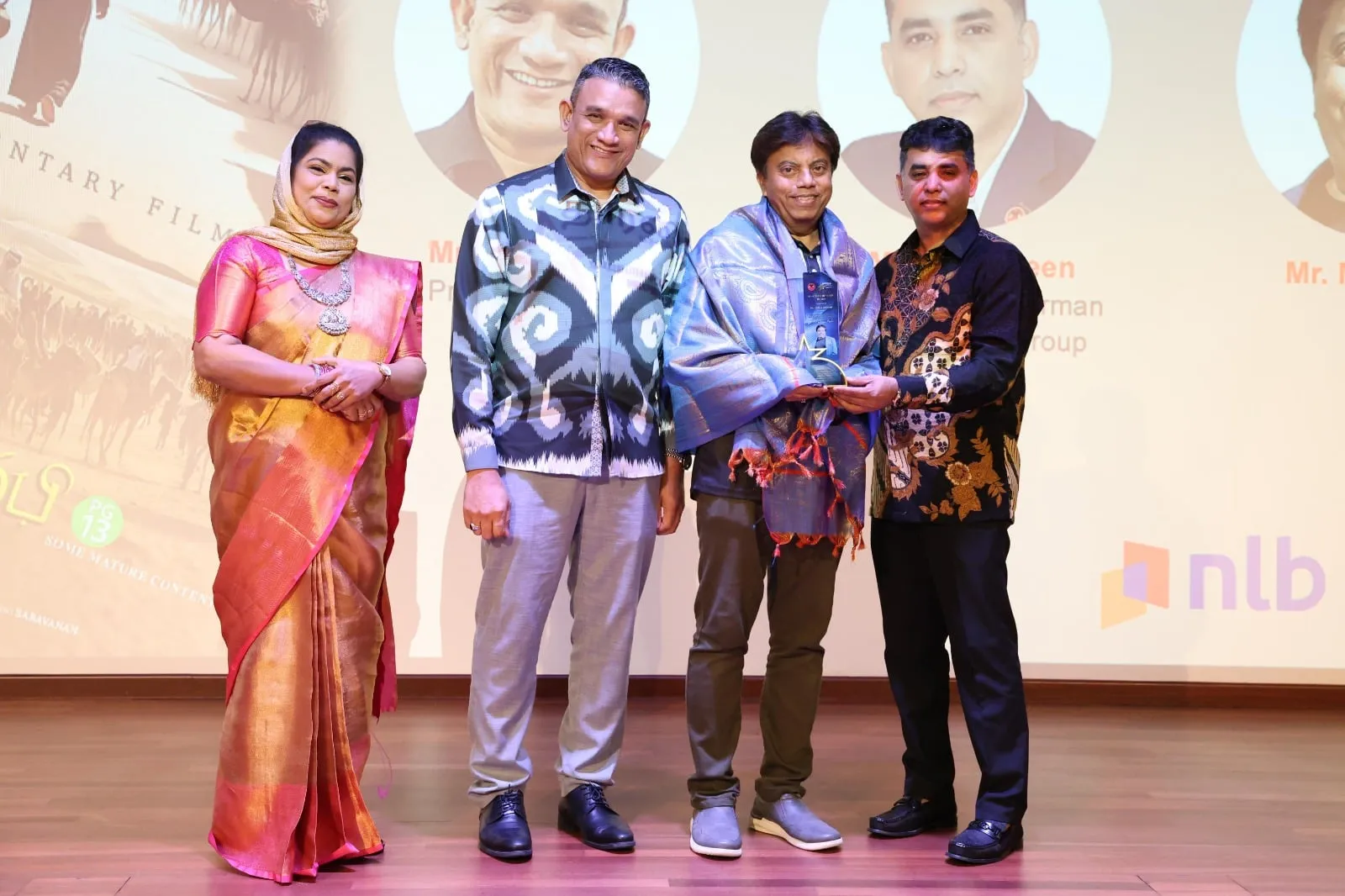 Director Millat Ahmad receiving the Best Documentary award for Meeladun Nabi in Singapore