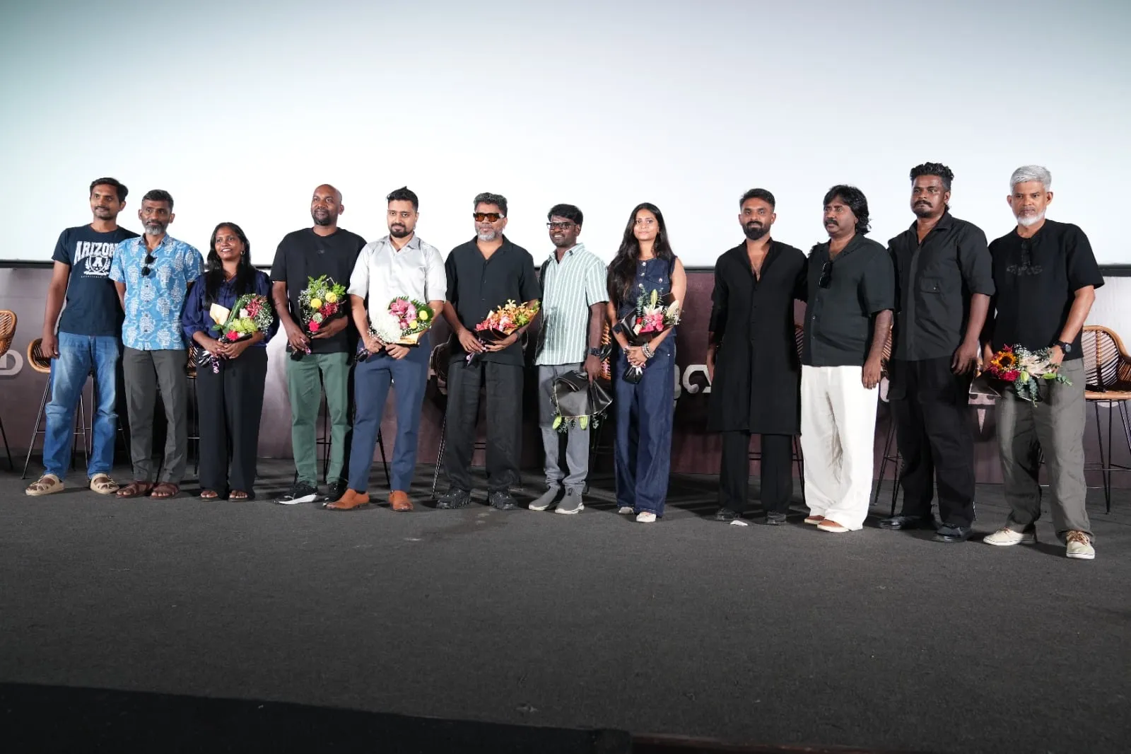 The Vettuvam cast and crew line up onstage at the World of Vettuvam presentation