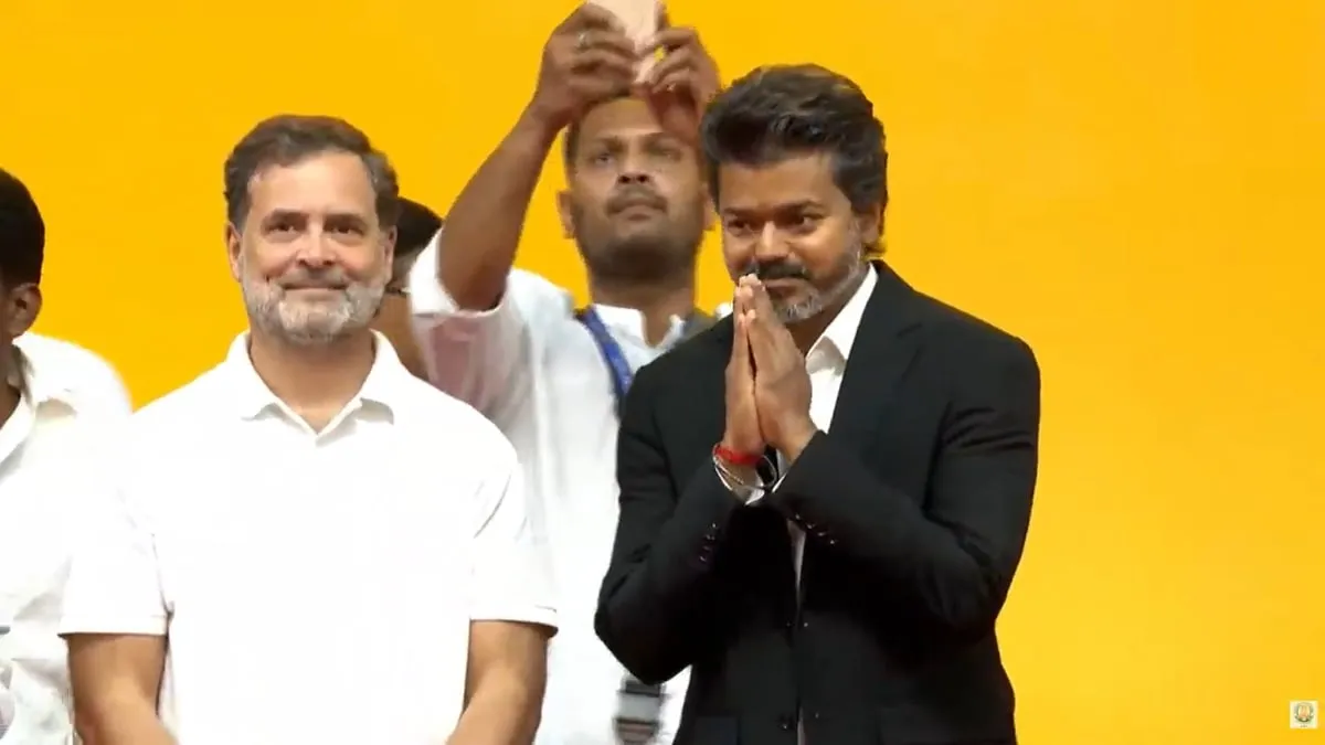 Vijay folds his hands to a packed Jawaharlal Nehru Indoor Stadium with Lok Sabha leader of opposition Rahul Gandhi visible behind him