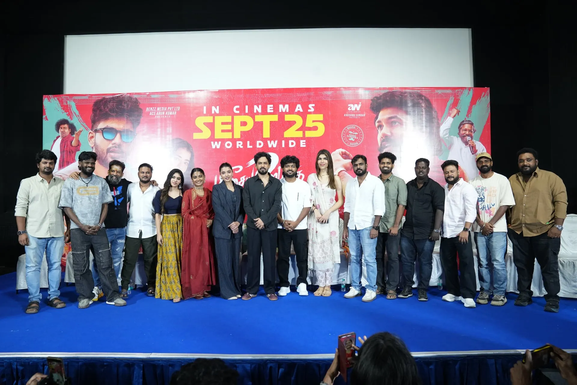 Hiphop Tamizha Adhi and the Meesaya Murukku 2 cast and crew stand together beneath the September 25 release backdrop