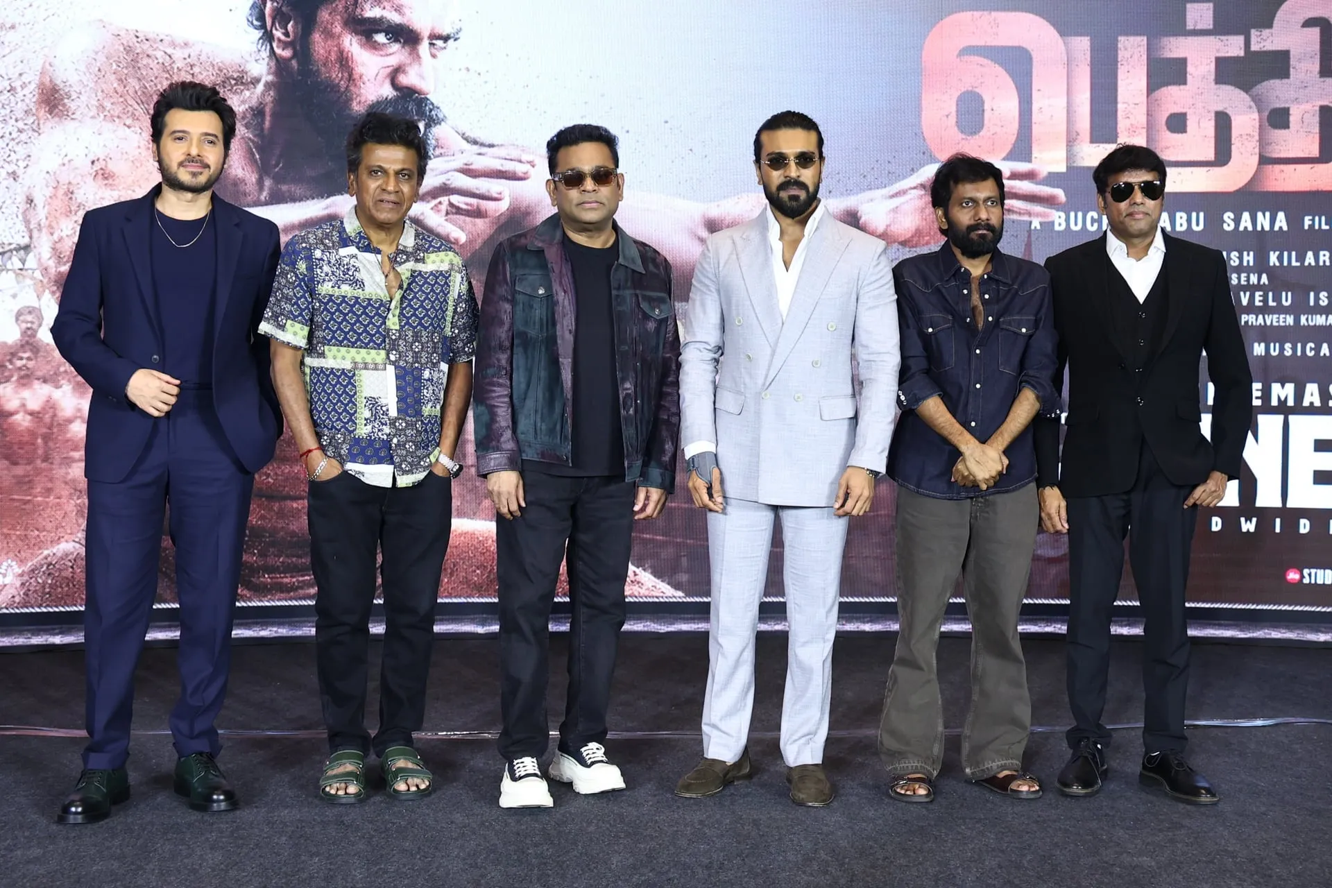 Ram Charan with the Peddi team, including A.R. Rahman and Shiva Rajkumar, at the film's Chennai event