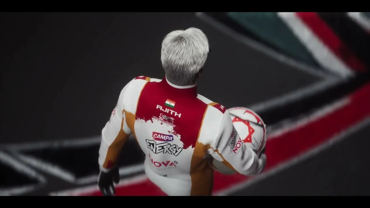 Ajith Kumar from behind in his red and white racing suit, helmet held under his arm, on a black race track