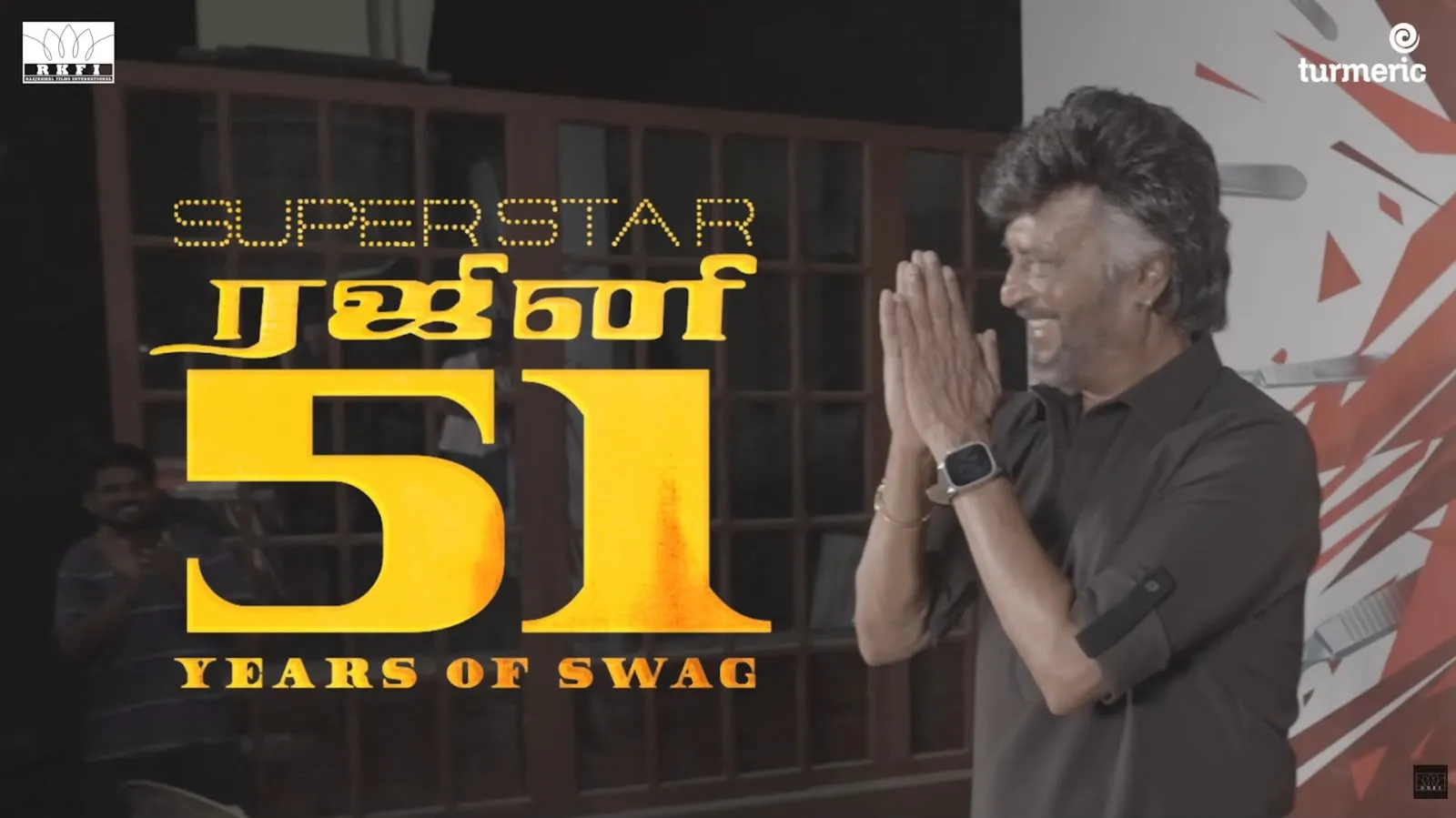 Rajinikanth folds his hands in a namaste beside a Superstar Rajini 51 Years of Swag graphic on the Dharman set