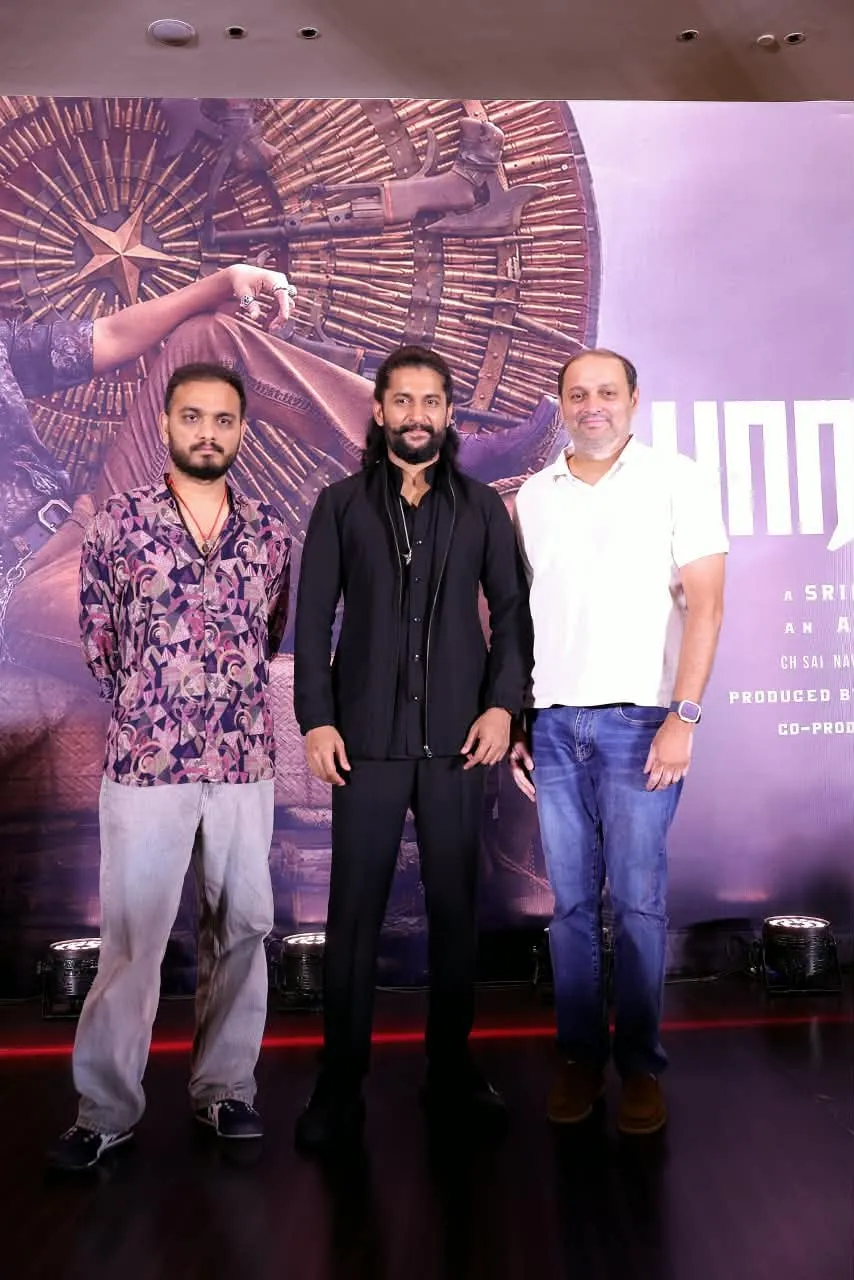 Nani stands between two members of The Paradise team at the Chennai event