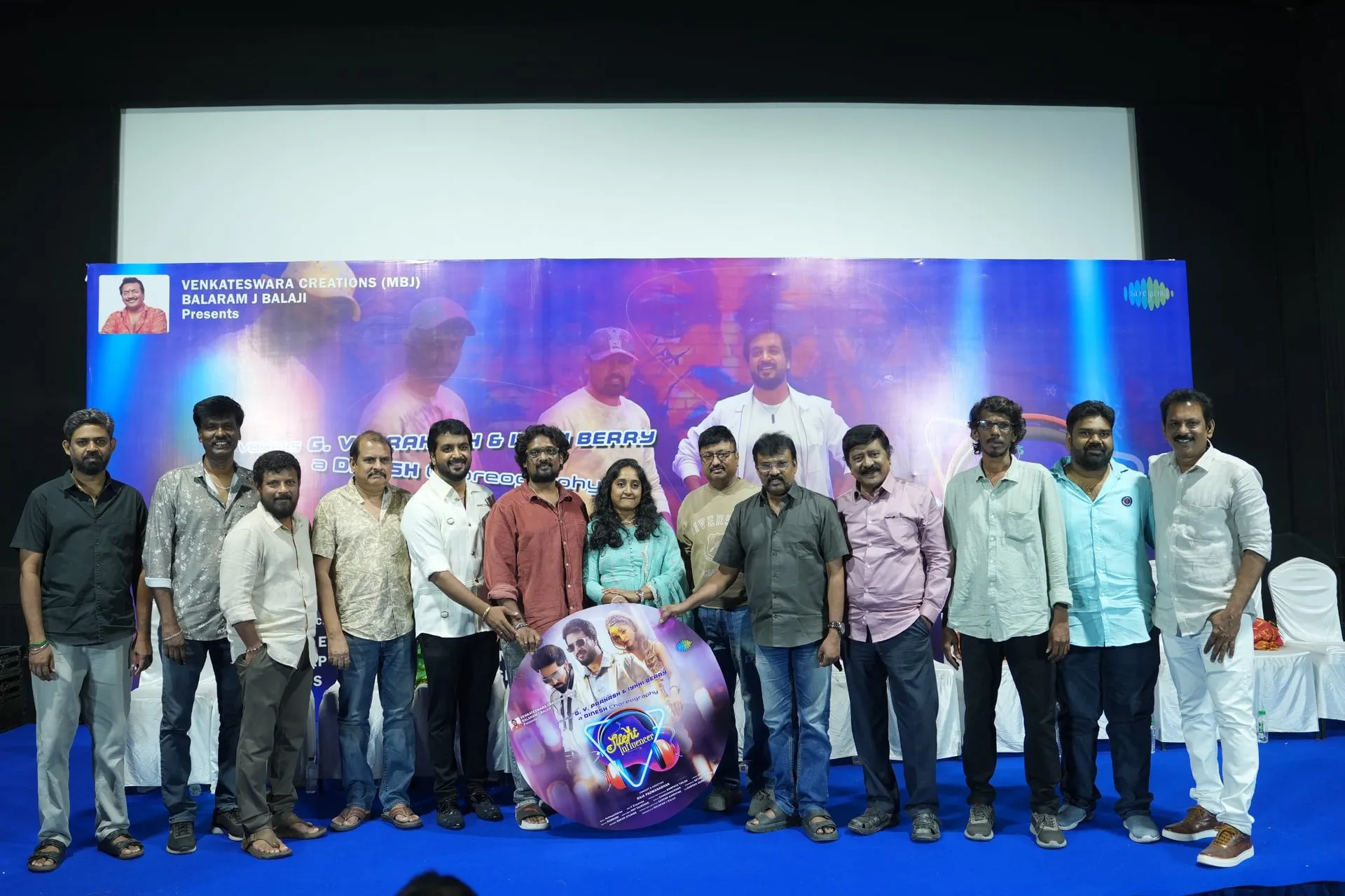Cast and crew on stage at the Silent Influencer audio launch in Chennai, with Balaram J. Balaji at the centre and the album disc held up between them.