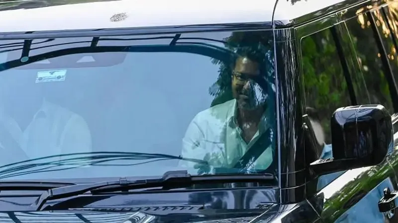 Vijay inside his SUV outside Raj Bhavan, photographed through the windshield.
