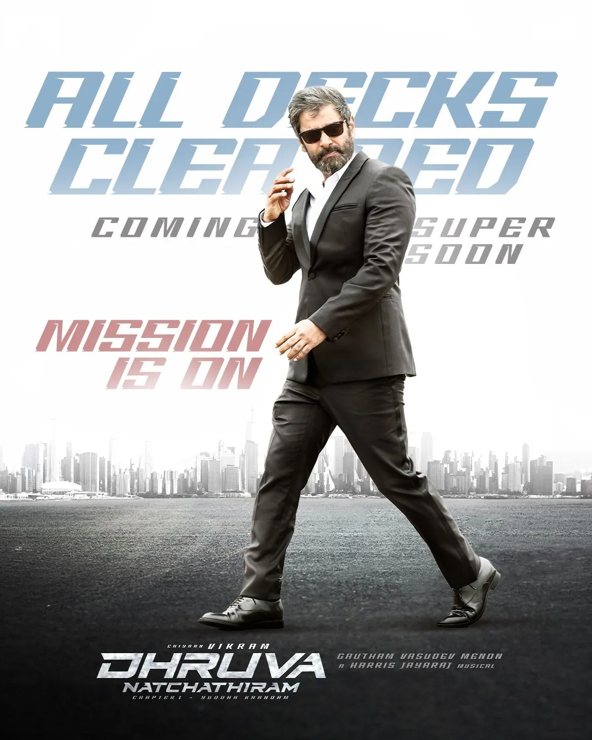 Dhruva Natchathiram All Decks Cleared poster with Vikram in a black suit.