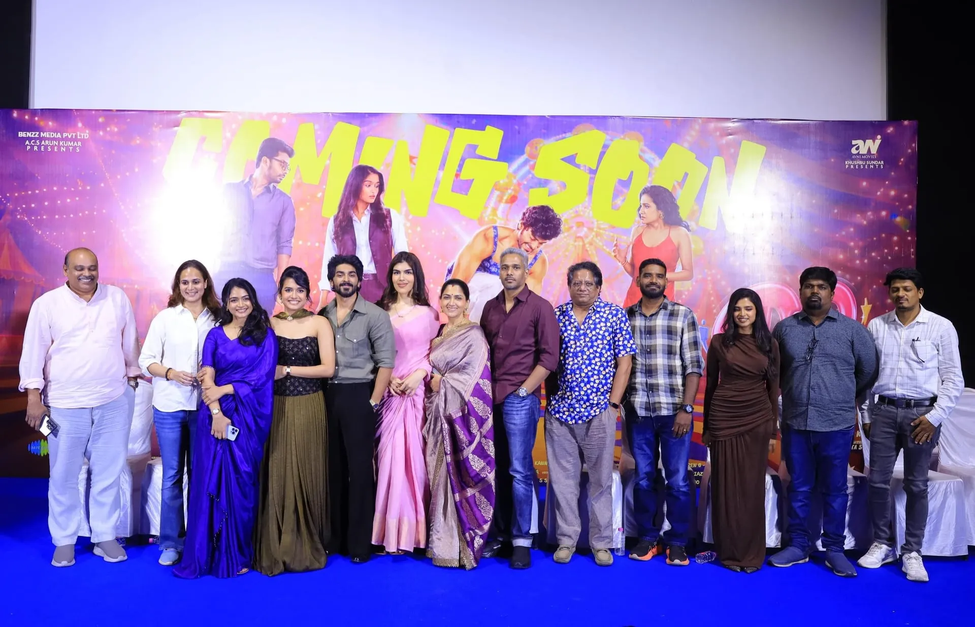 The cast and crew of Double Occupancy on stage in Chennai in front of the film's Coming Soon backdrop