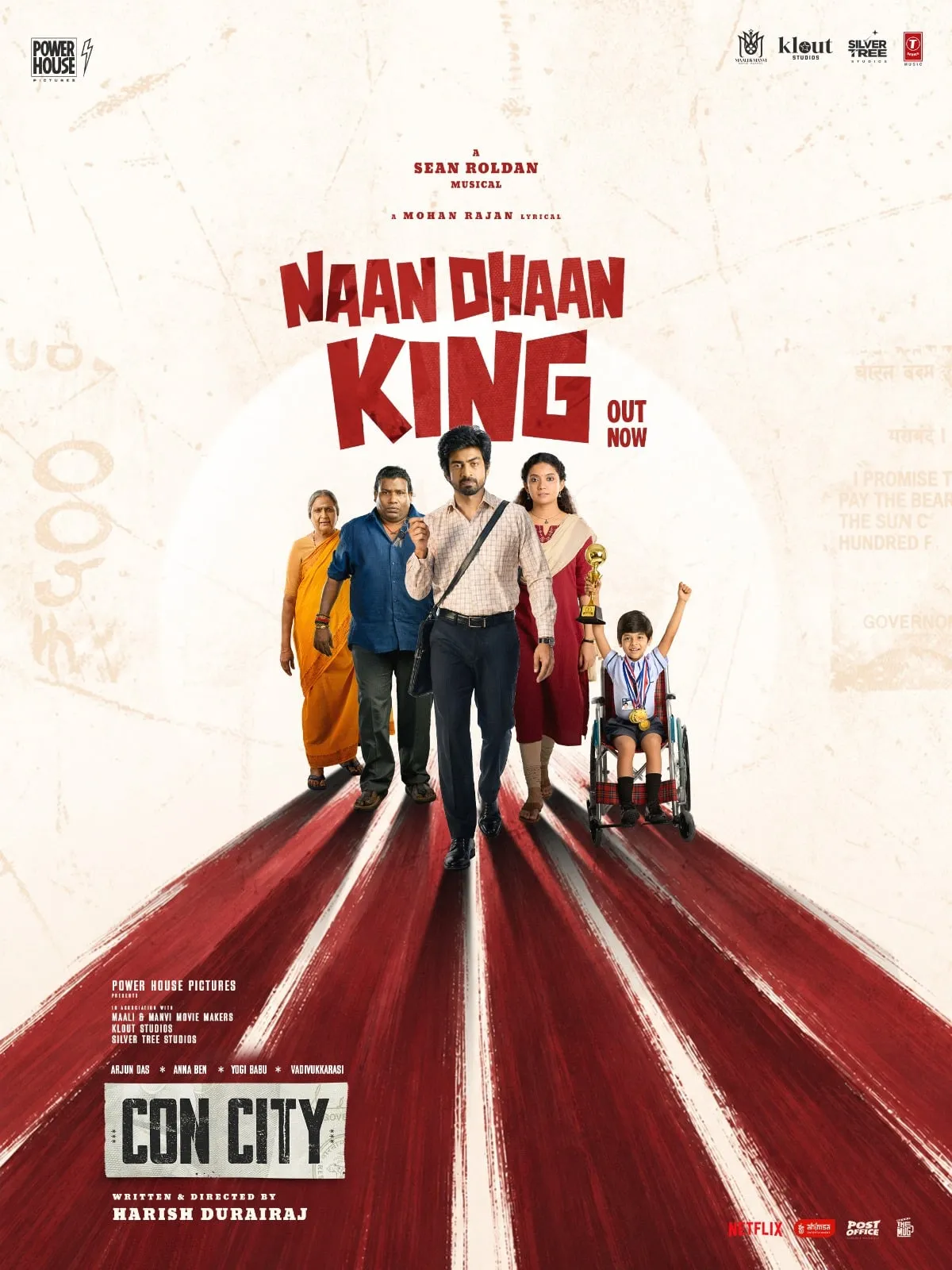 Naan Dhaan King poster with Arjun Das walking centre-frame down a red road, with Anna Ben, Yogi Babu, Vadivukkarasi and a child in a wheelchair holding a trophy aloft falling in behind him