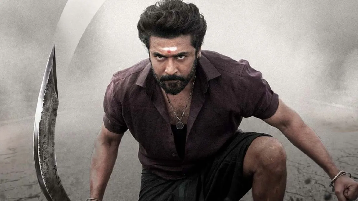 Suriya in the title role of Karuppu, crouched and holding the aruval sickle, in the dust-and-ash colour treatment RJ Balaji used for the film's hero key art
