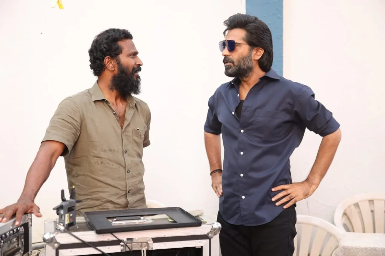 Vetrimaaran and Silambarasan in conversation beside a monitor on the Arasan set