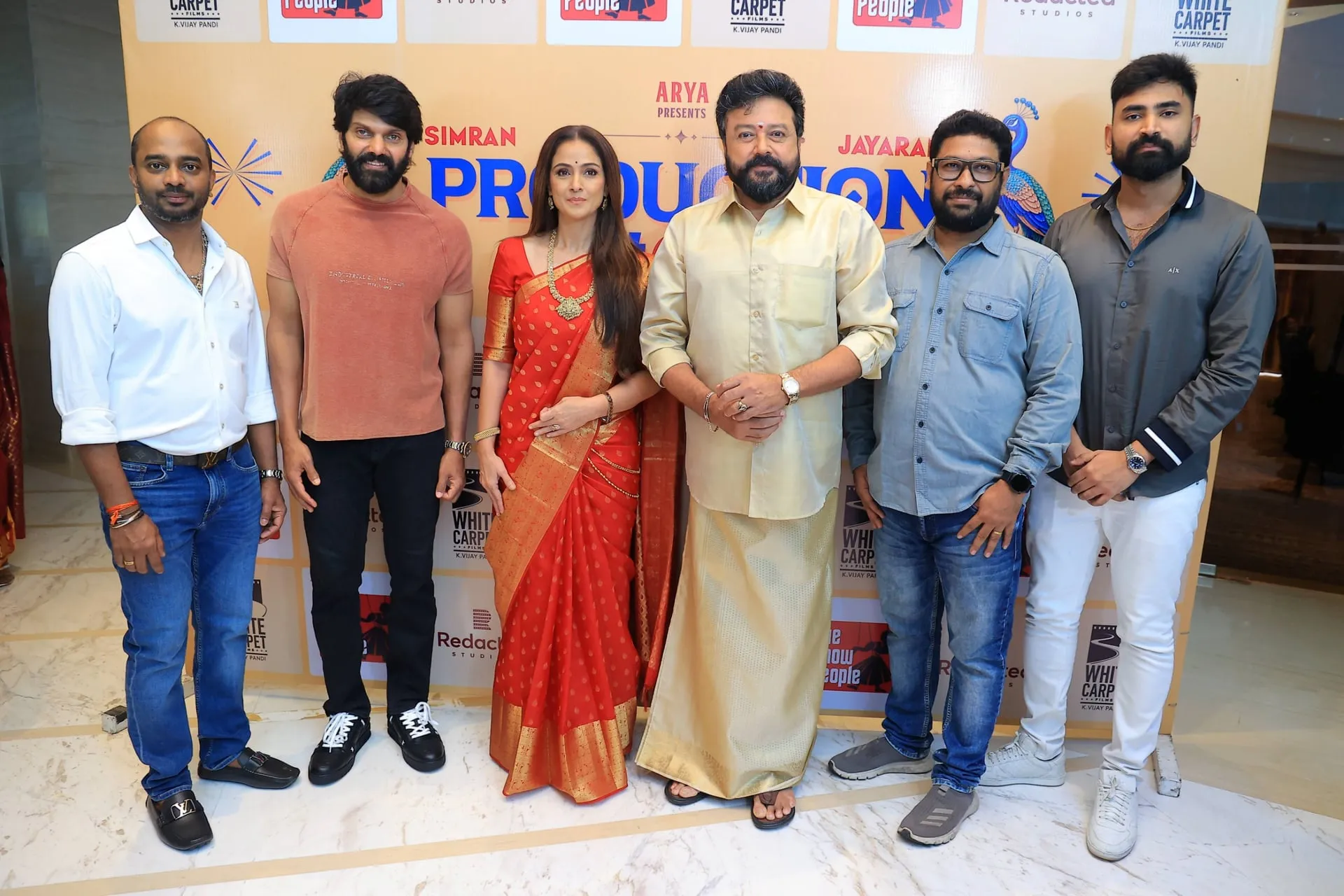 Jayaram and Simran with presenter Arya, director SY Gowthamraj and the producers at the launch of their new family rom-com