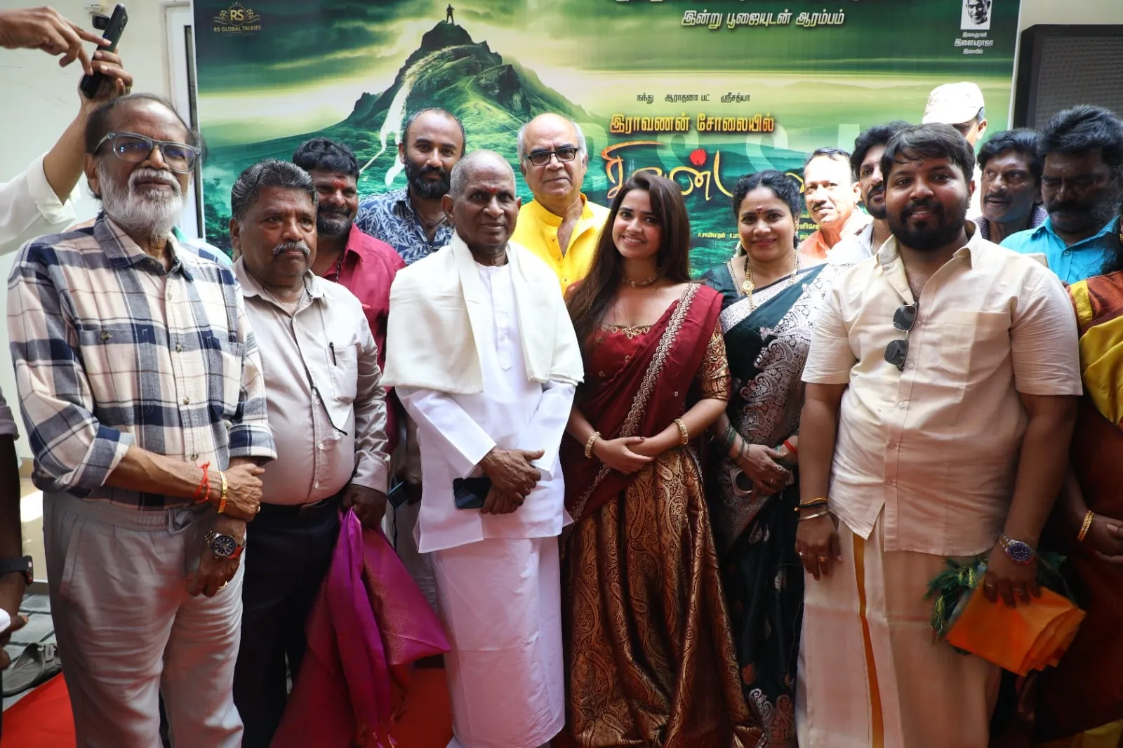 The Iravanan Solaiyil Sivan Malai team gathered in front of the film's backdrop at its launch