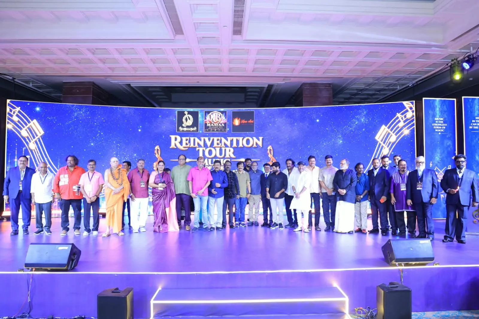 Composers, lyricists and film personalities line up on stage in front of the Reinvention Tour backdrop
