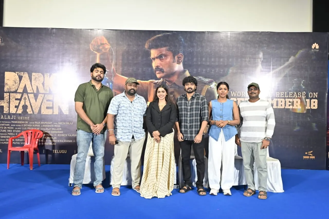 The Dark Heaven team together in front of the film's September 18 release backdrop