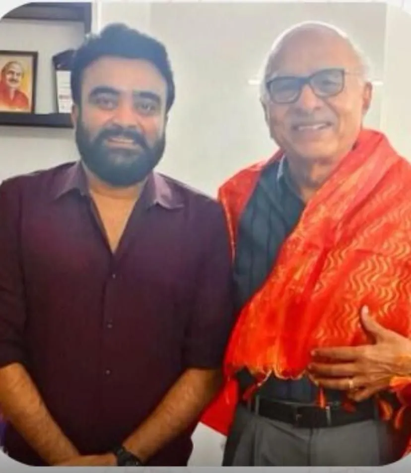Actor Udhaya standing alongside producer RB Choudary at the Super Good Films office
