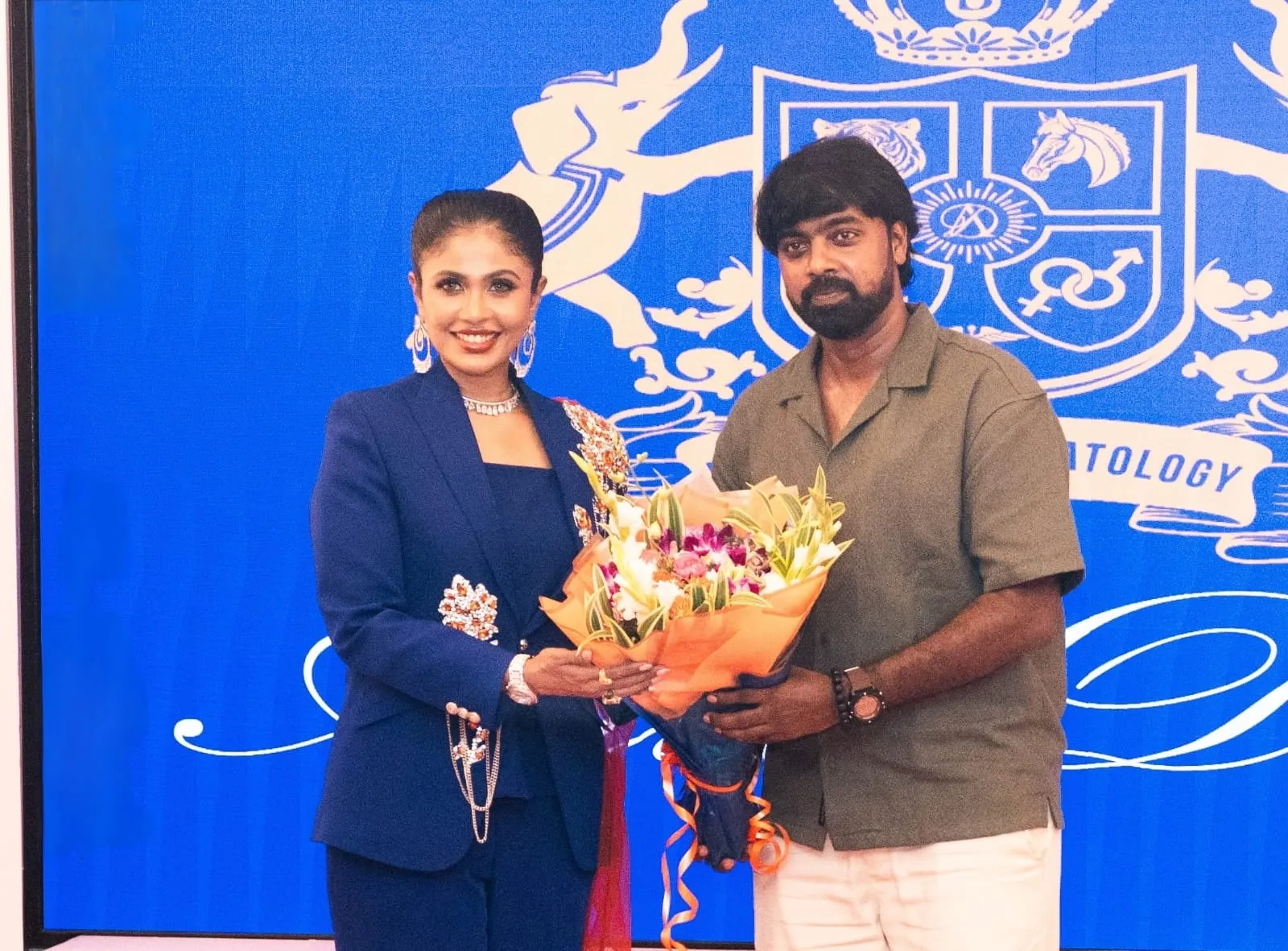Pari Elavazhagan, a long-time patient of Bhairavi Senthil, hands her a bouquet at the launch