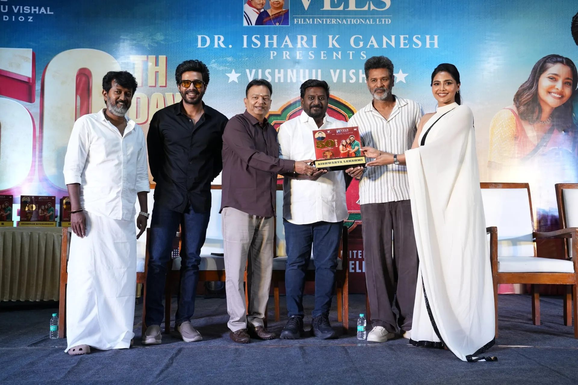 Aishwarya Lekshmi receives her shield onstage from Prabhu Deva and Ishari K Ganesh