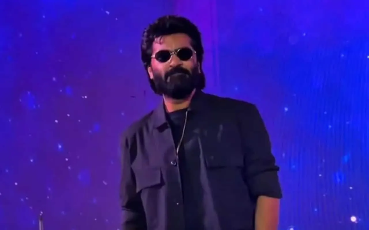 Silambarasan in dark glasses on stage at the Chennai college event where he spoke about Arasan