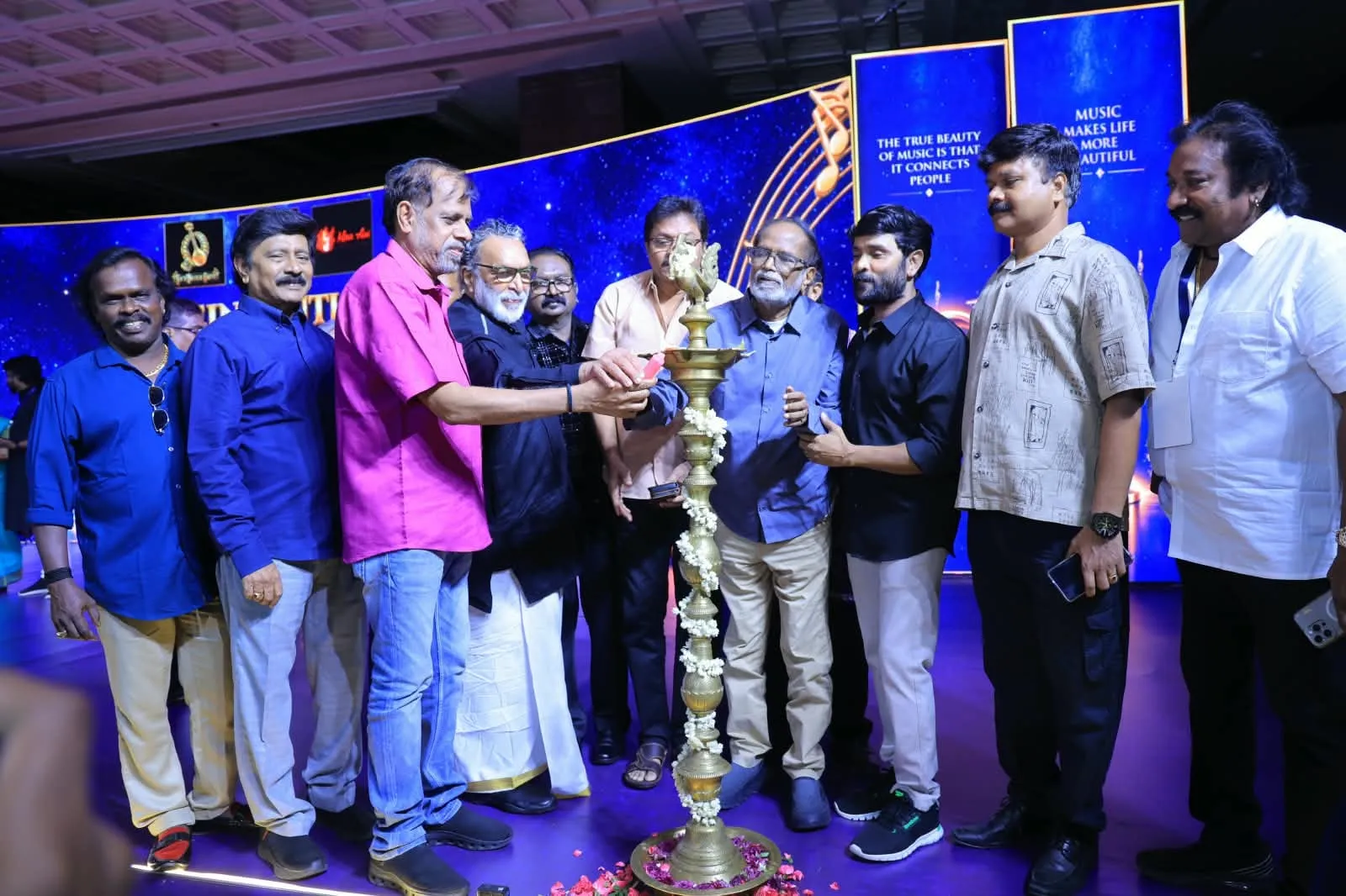 Composers and union office-bearers gather around a brass lamp as it is lit to open the Reinvention Tour