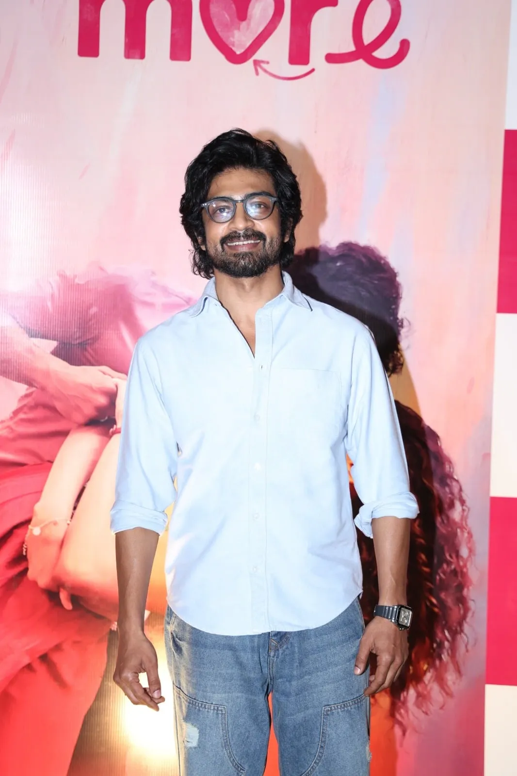 Arjun Das at the Once More trailer launch, in front of the film's poster