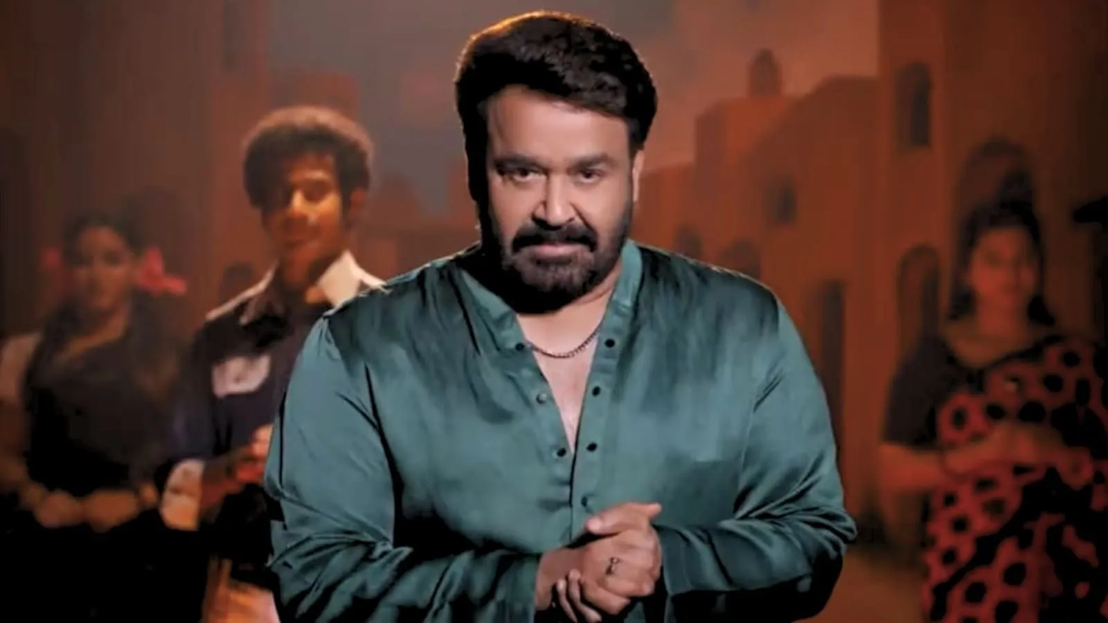 Mohanlal in a teal kurta in the festival's campaign teaser, framed against an old-town set with dancers in the back.