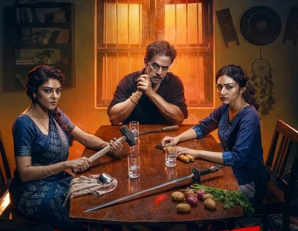 The Rajaram family at their dining table, fresh vegetables piled on one side and a sledgehammer, sword and knife laid out on the other
