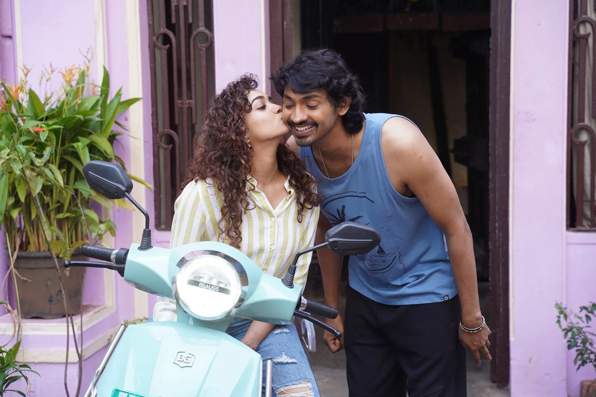 Saanve Meghana kisses Elan on the cheek beside a mint-green scooter in Pyaar Prema Kalyanam