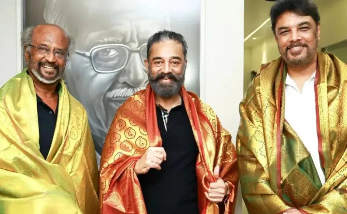 Rajinikanth, Kamal Haasan and Sundar C draped in ceremonial shawls, posing together at an event