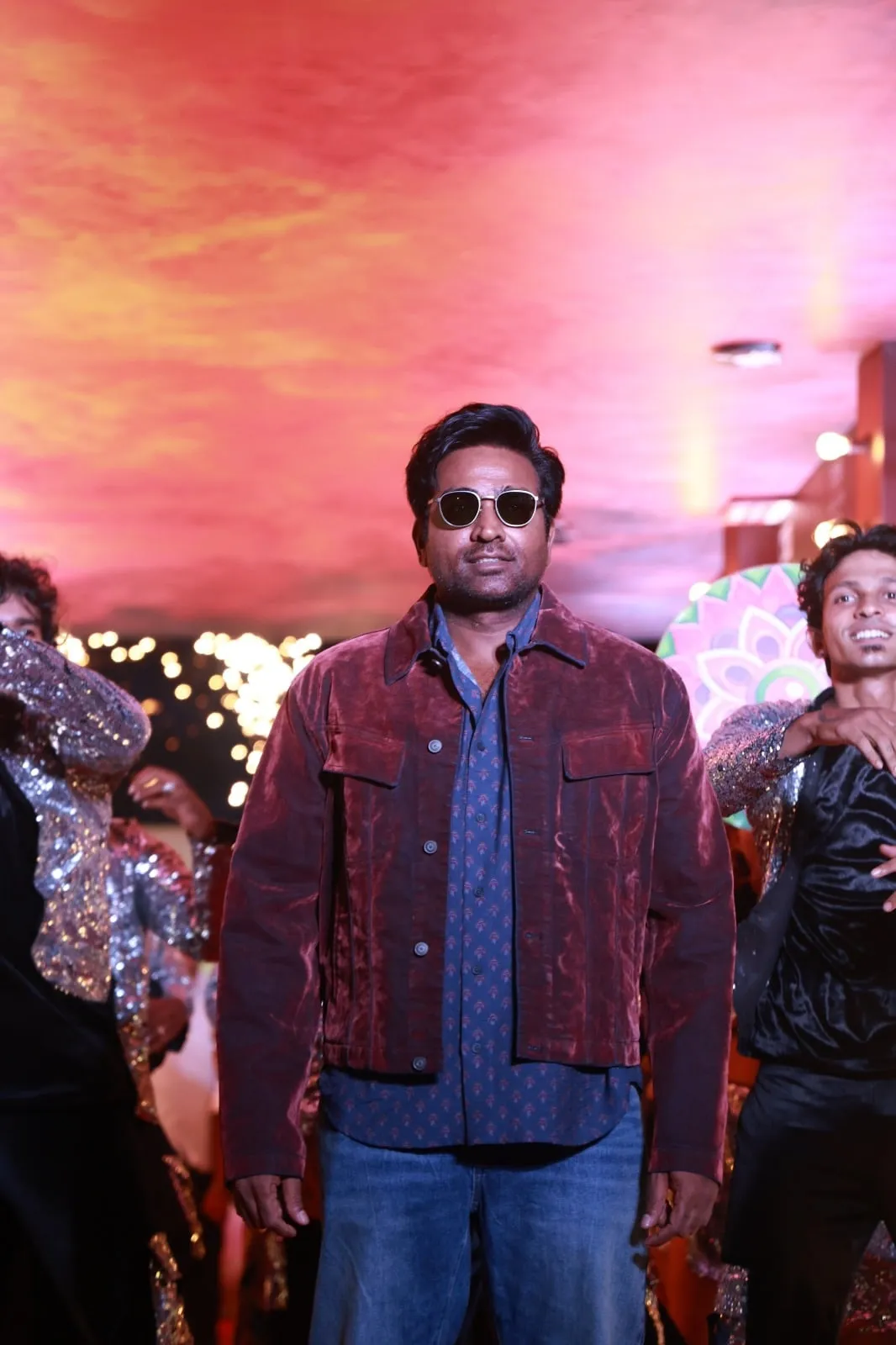 A guest in sunglasses walks through the Baththa music launch