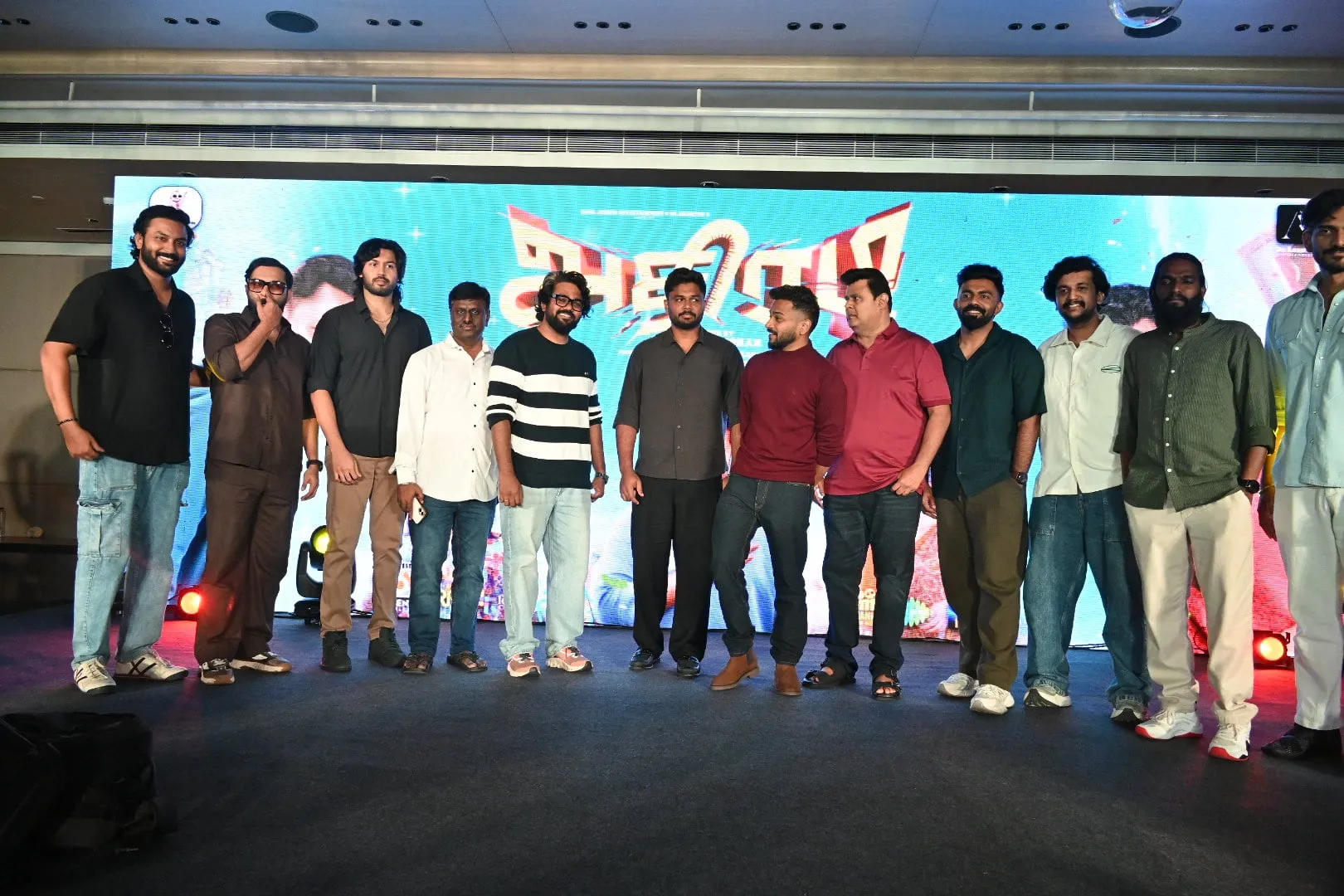 The Athiradi team on stage at the Chennai pre-release event, in front of the film's backdrop