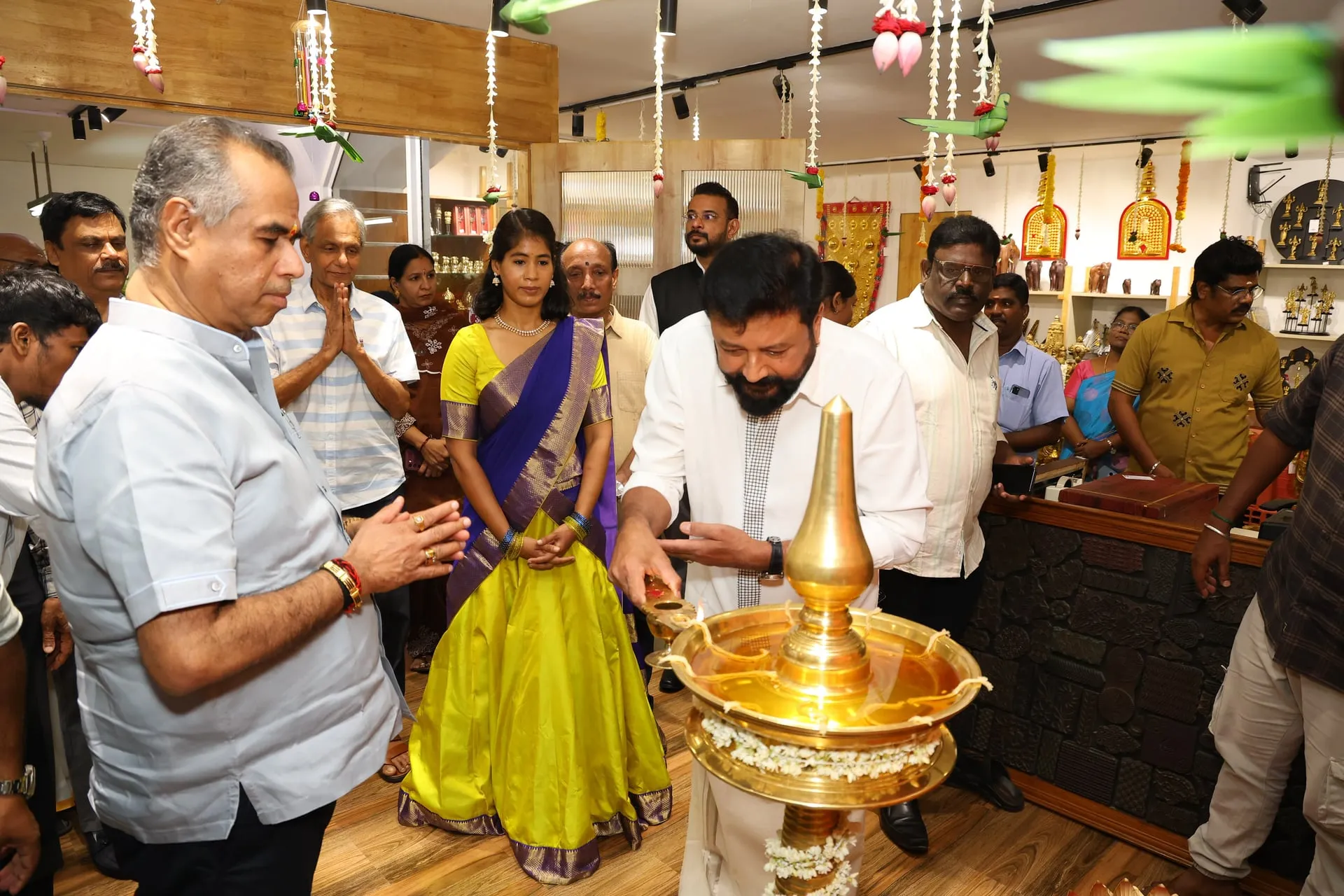 Jayaram lights the ceremonial lamp at the opening of Sabari Artisans Village