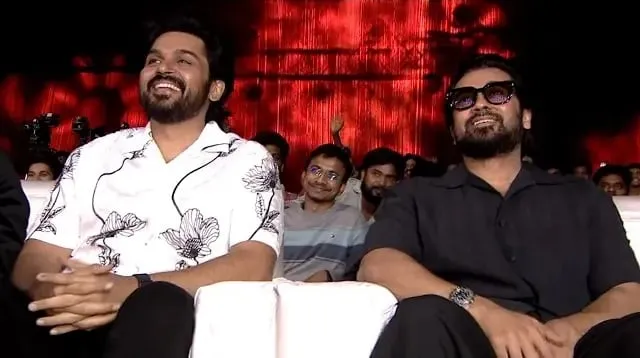 Karthi and Suriya in the front row at the Karuppu pre-release event in Hyderabad, sharing a laugh during the speeches.