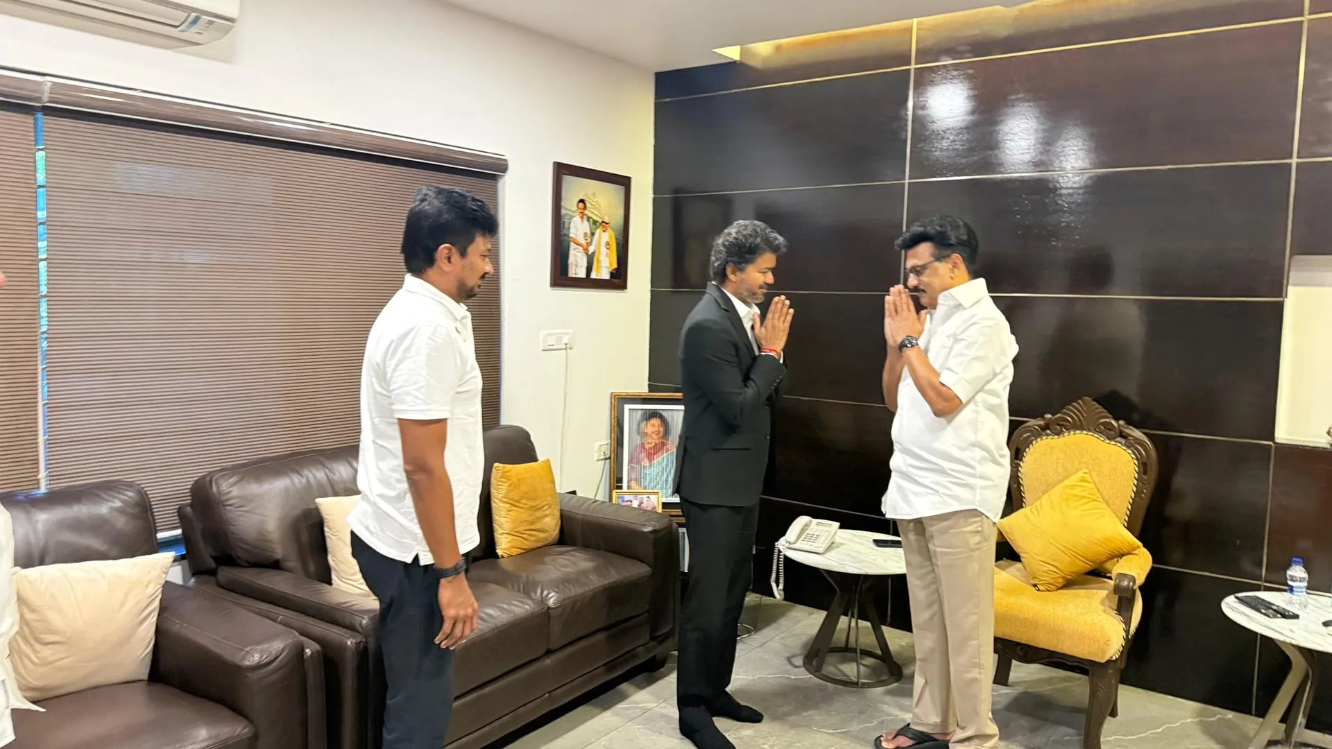 Vijay and Stalin in folded-palms greeting, with Udhayanidhi watching from the left.