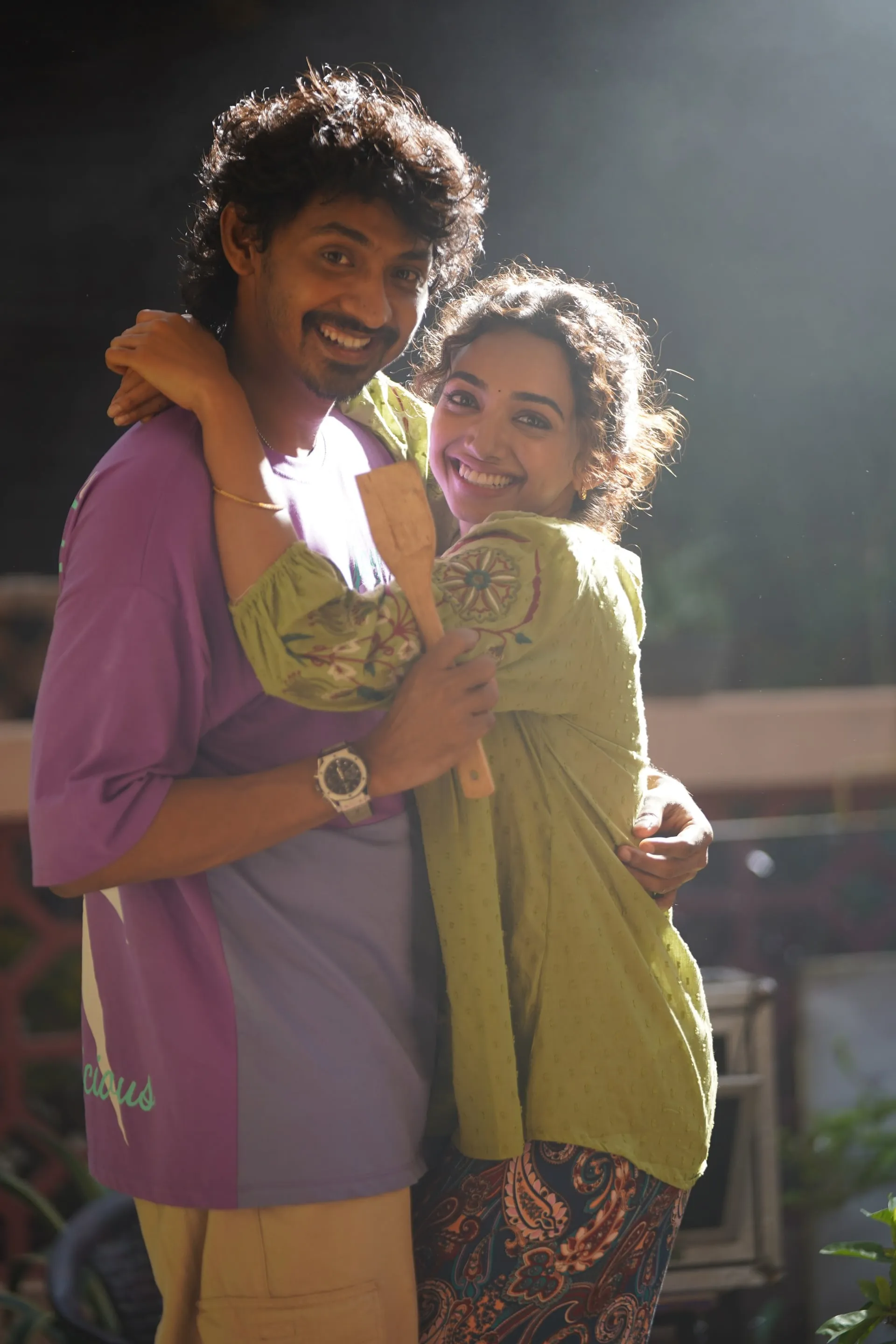 Elan grins with a wooden spatula in hand as Saanve Meghana hugs him in Pyaar Prema Kalyanam