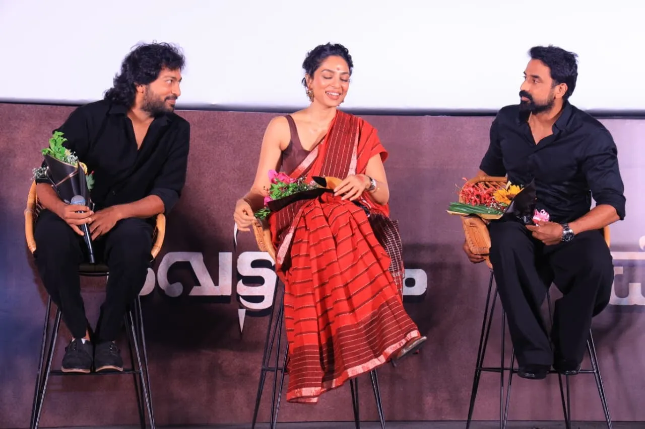 Cast members talk onstage during the World of Vettuvam presentation