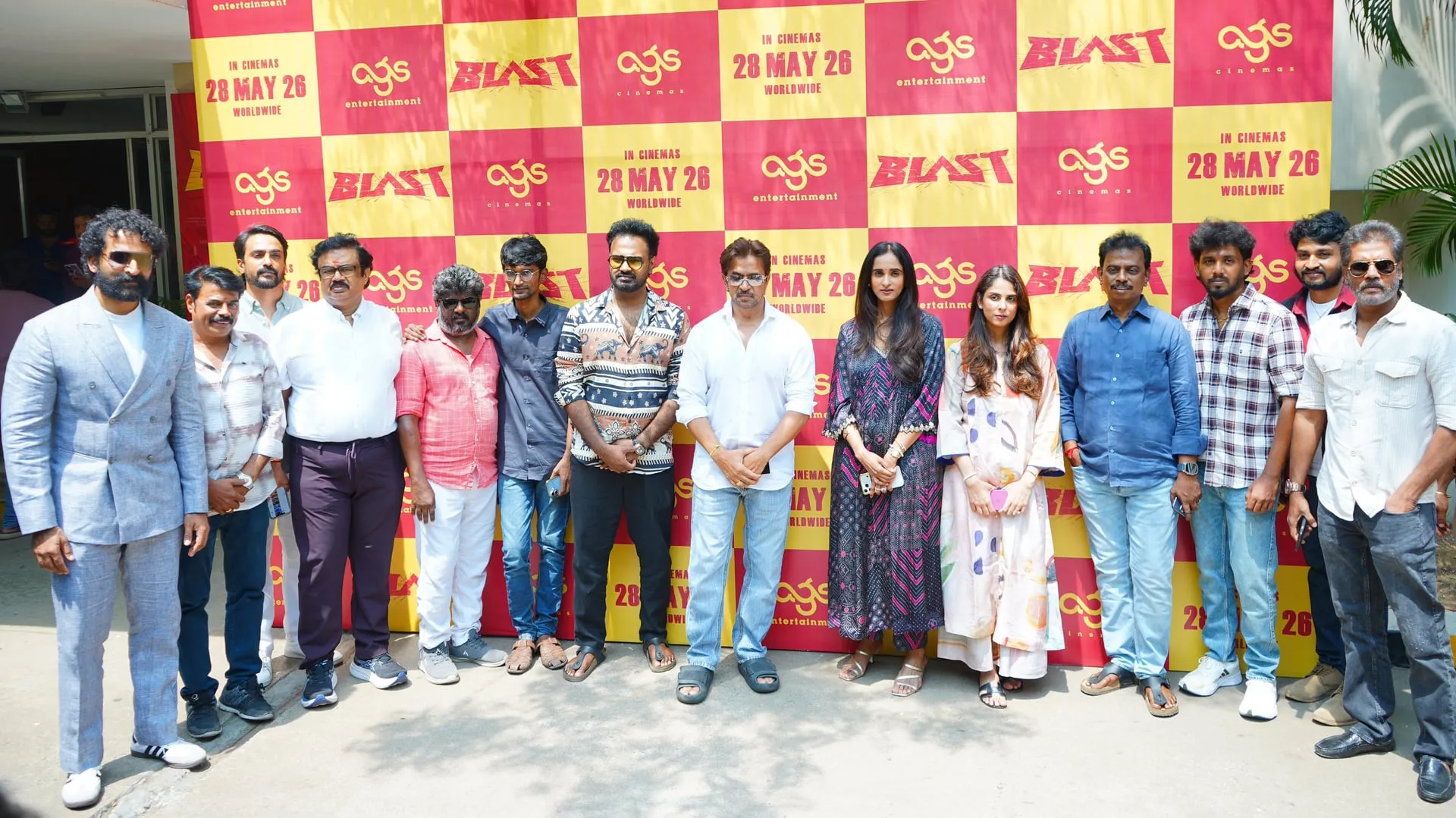 The Blast cast and crew outdoors against the AGS step-and-repeat at Monday's pre-release event