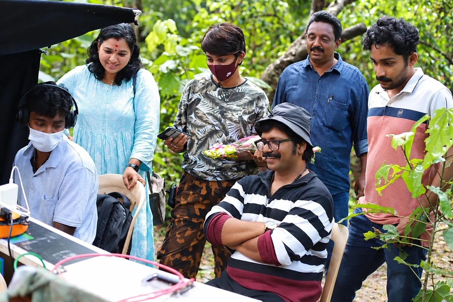 The Thaainilam crew at the monitor during a location shoot