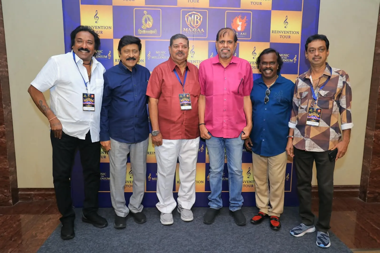 Veteran composers and union members pose together in front of the Reinvention Tour backdrop