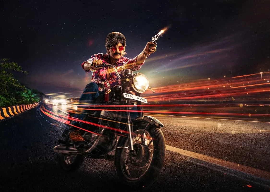 Vishal as young Linga fires a pistol while riding a motorcycle down a highway at night
