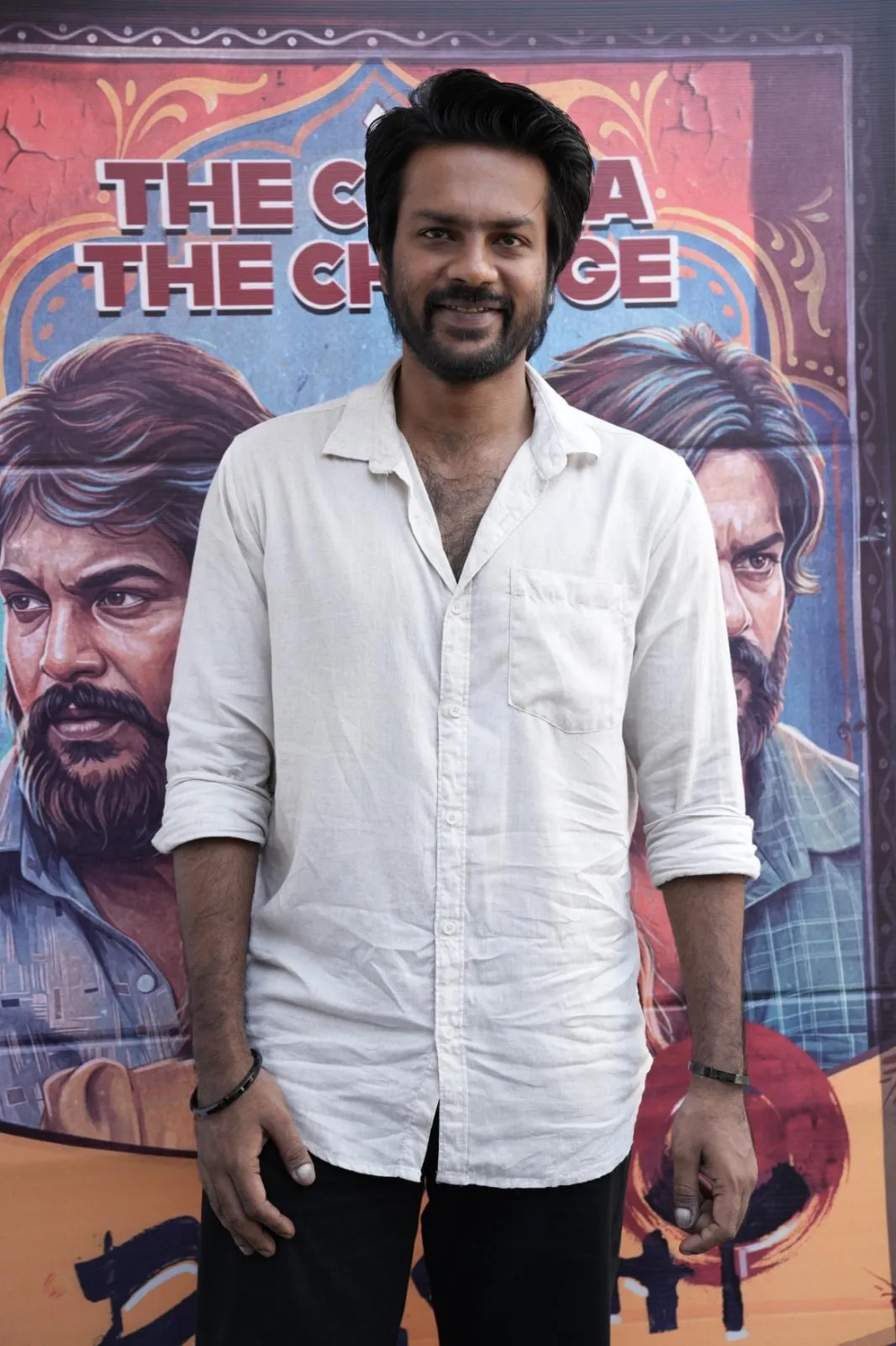Actor in front of a Dorothy poster at the thanksgiving event