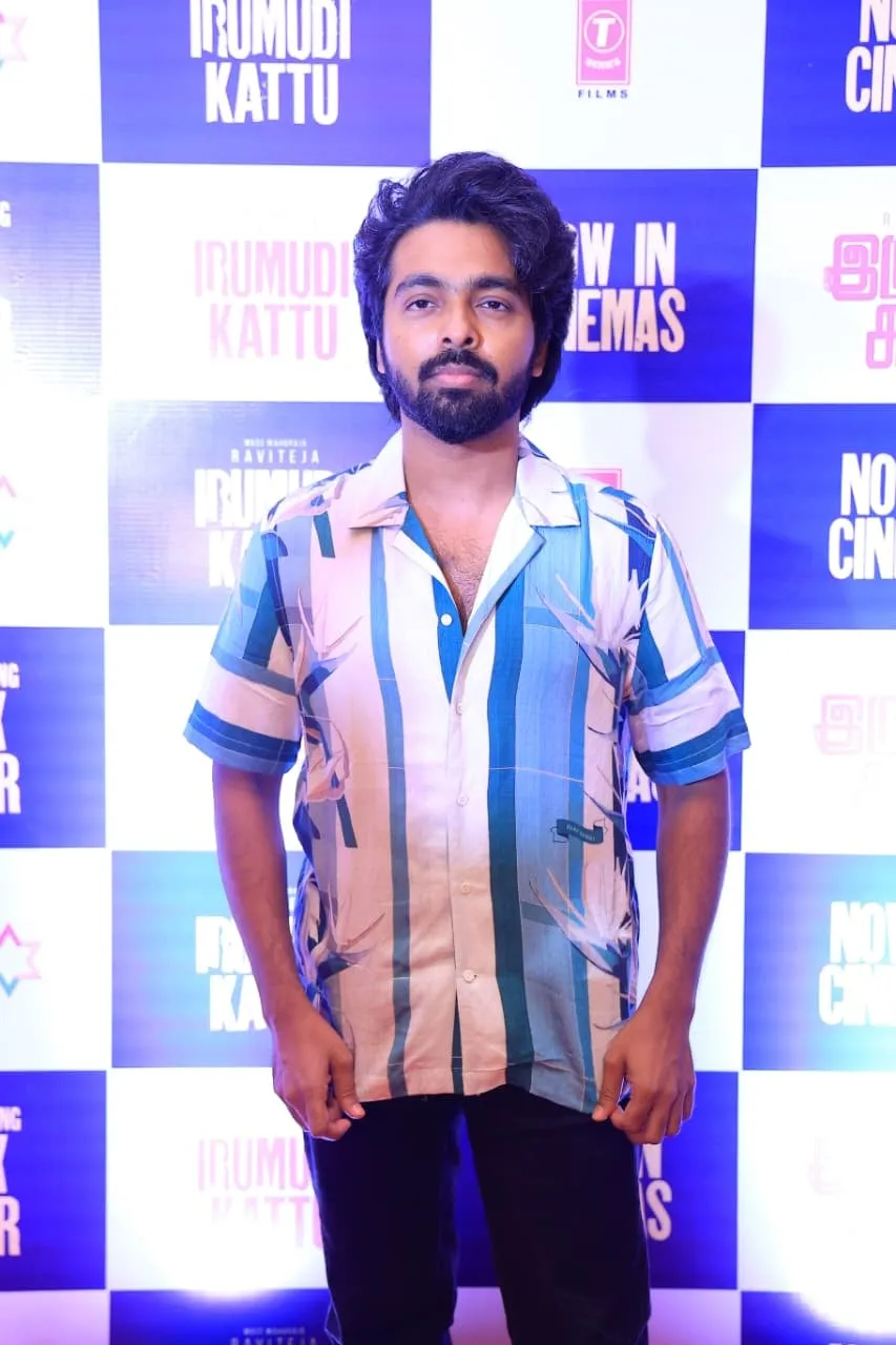 G.V. Prakash Kumar at the Irumudi Kattu event in front of the film's poster wall