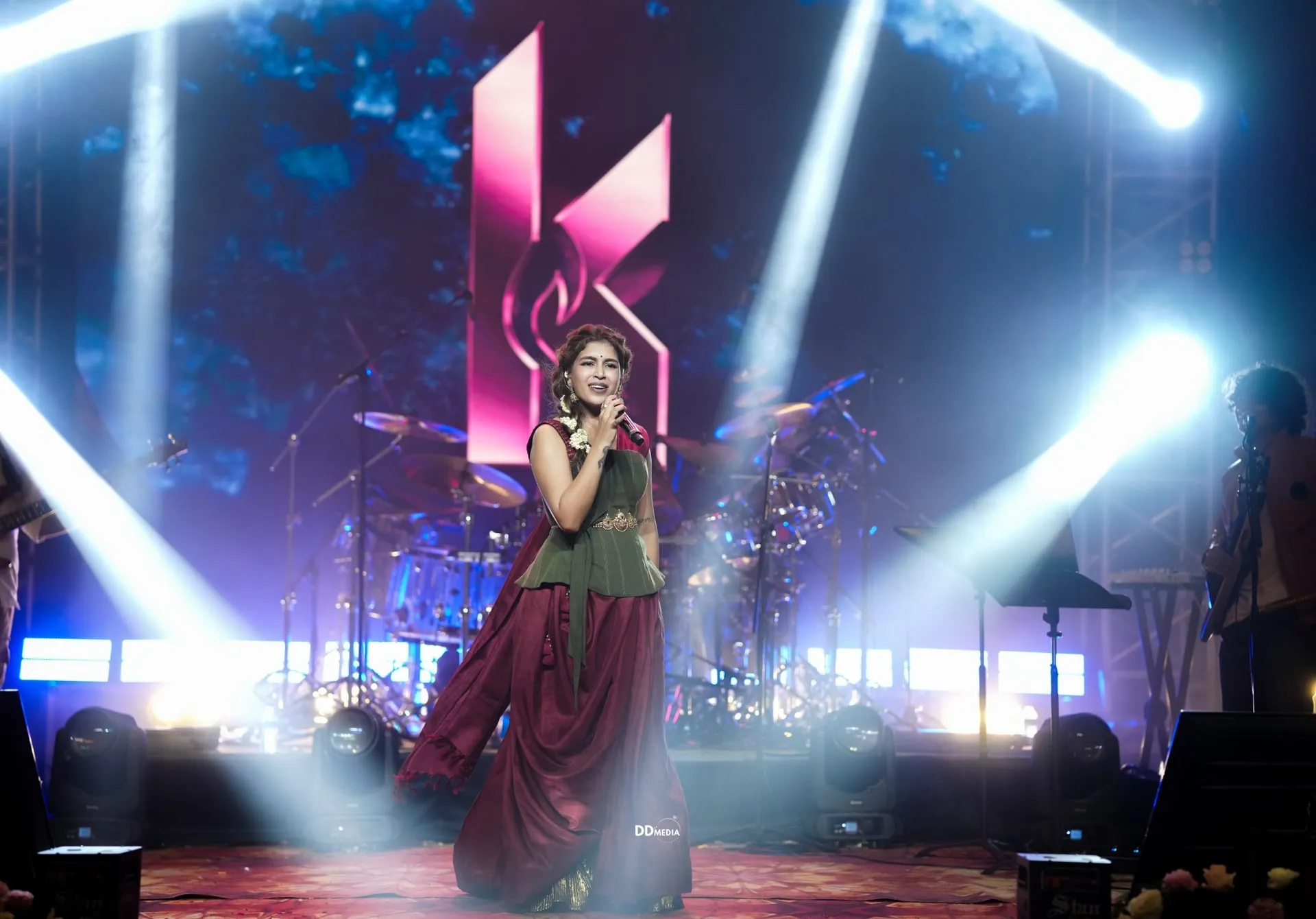 Keneeshaa fronting her band at Utsav 2026; the singer is Ravi Mohan's off-stage partner, making the night a double family billing.