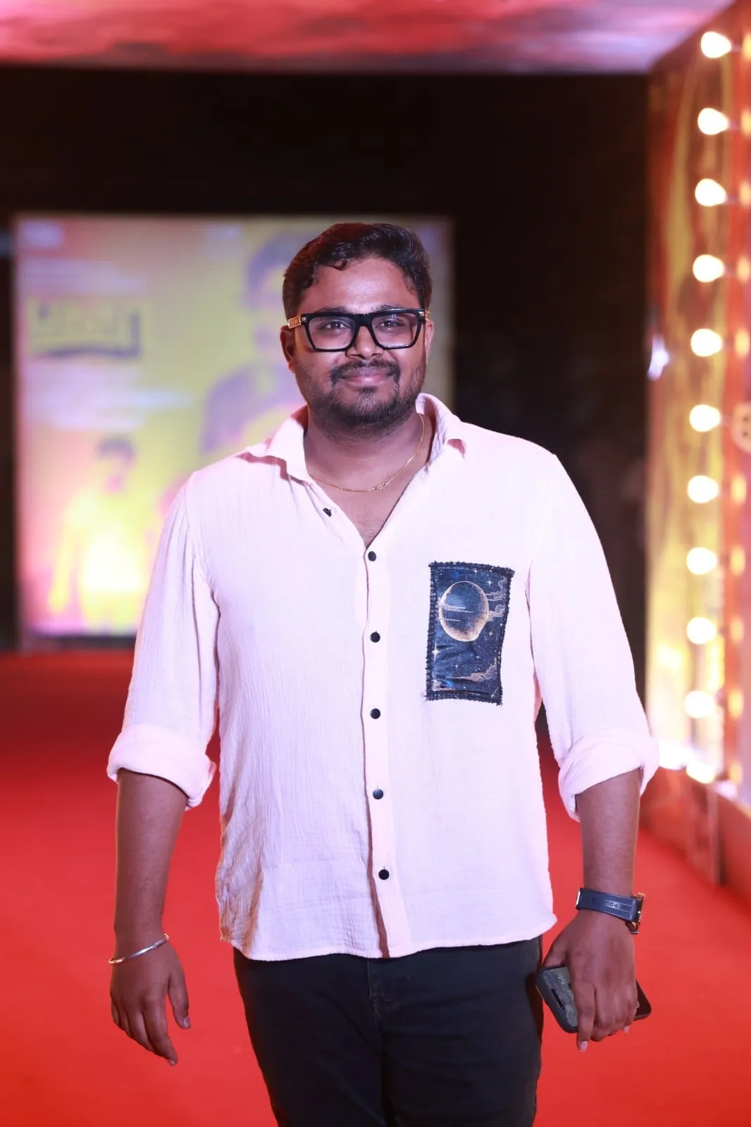 A guest poses in the arrival area for the Baththa launch