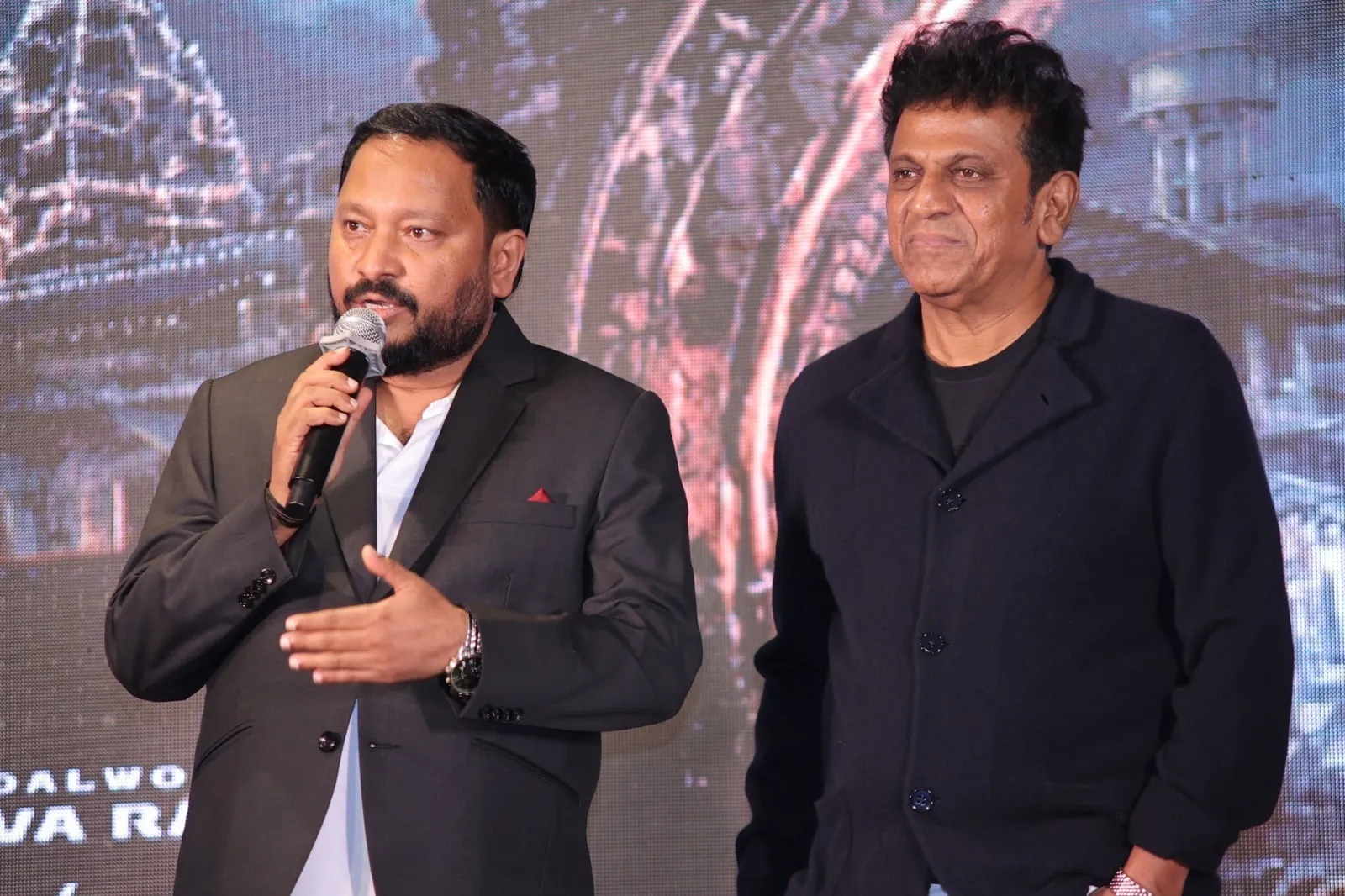 R. Chandru and Shivarajkumar on stage as the title is revealed