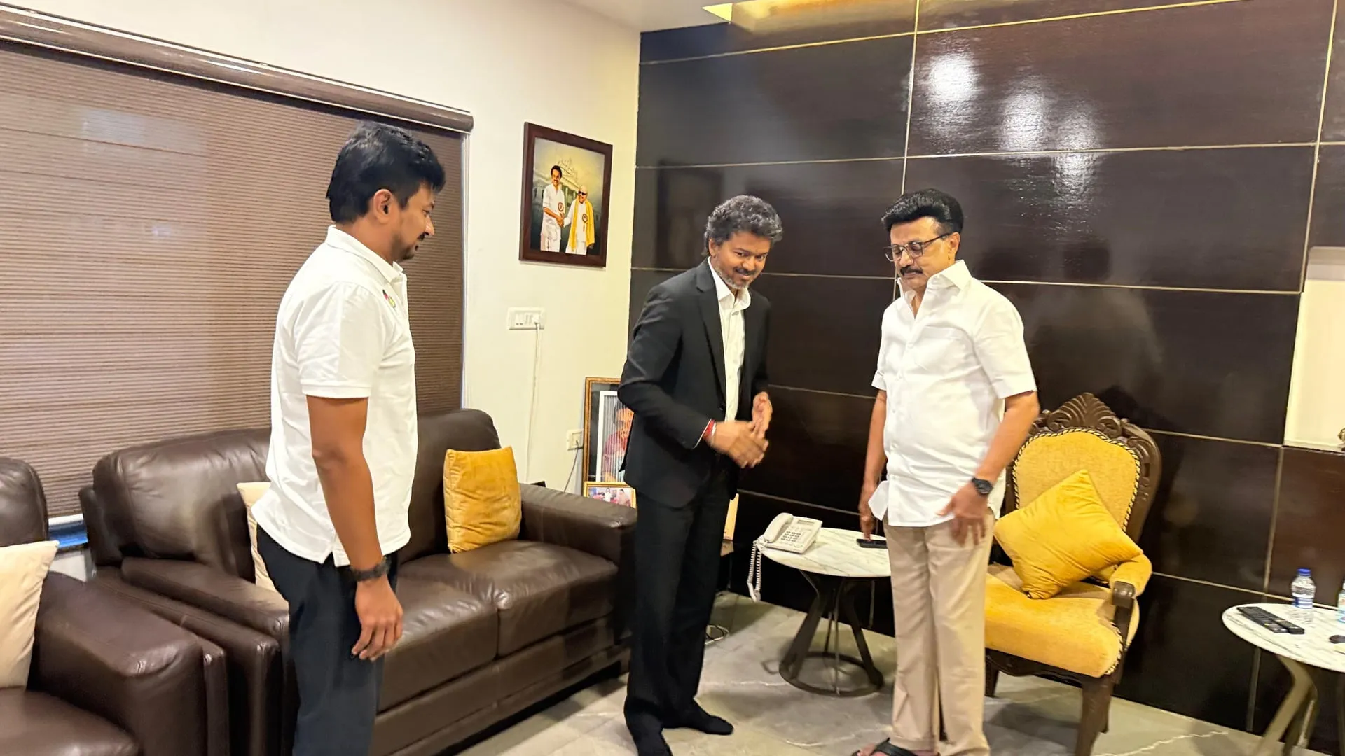 Stalin drapes a yellow silk shawl on Vijay, with Udhayanidhi holding a book on the right.