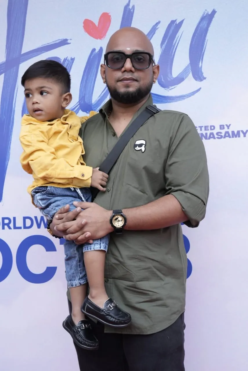 Guest holding a child at the Haiku audio launch